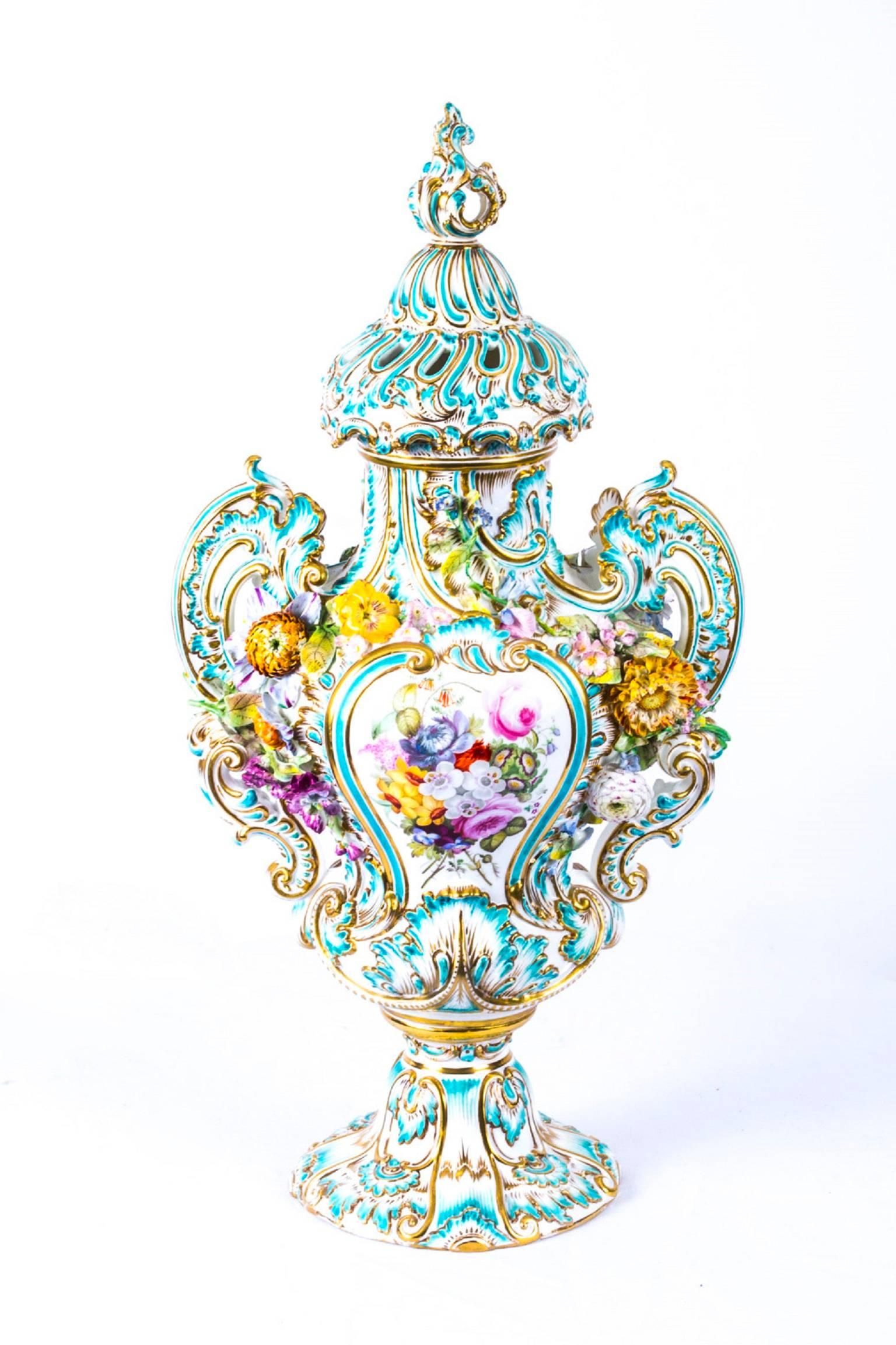 This is a beautiful large pair of Meissen Porcelain vases and covers, circa 1810.

Each is encrusted with finely modelled flowers in high relief with superb gilded highlights and hand-painted each side with floral panels.

The lids have pierced