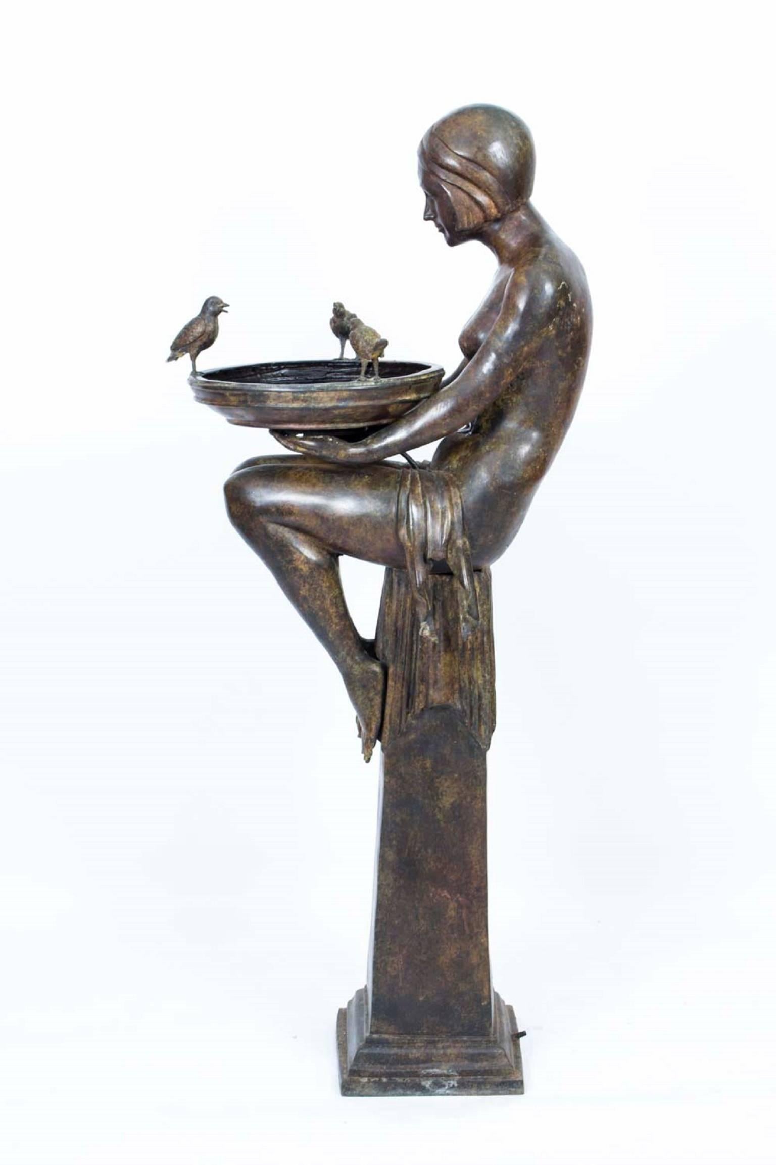 An absolutely stunning solid bronze Art Deco style jardinière in the form of two seated semi naked ladies with classic Art Deco bob hair style holding a jardinière with three perched birds singing, raised on an elegant tapering stand, from the last