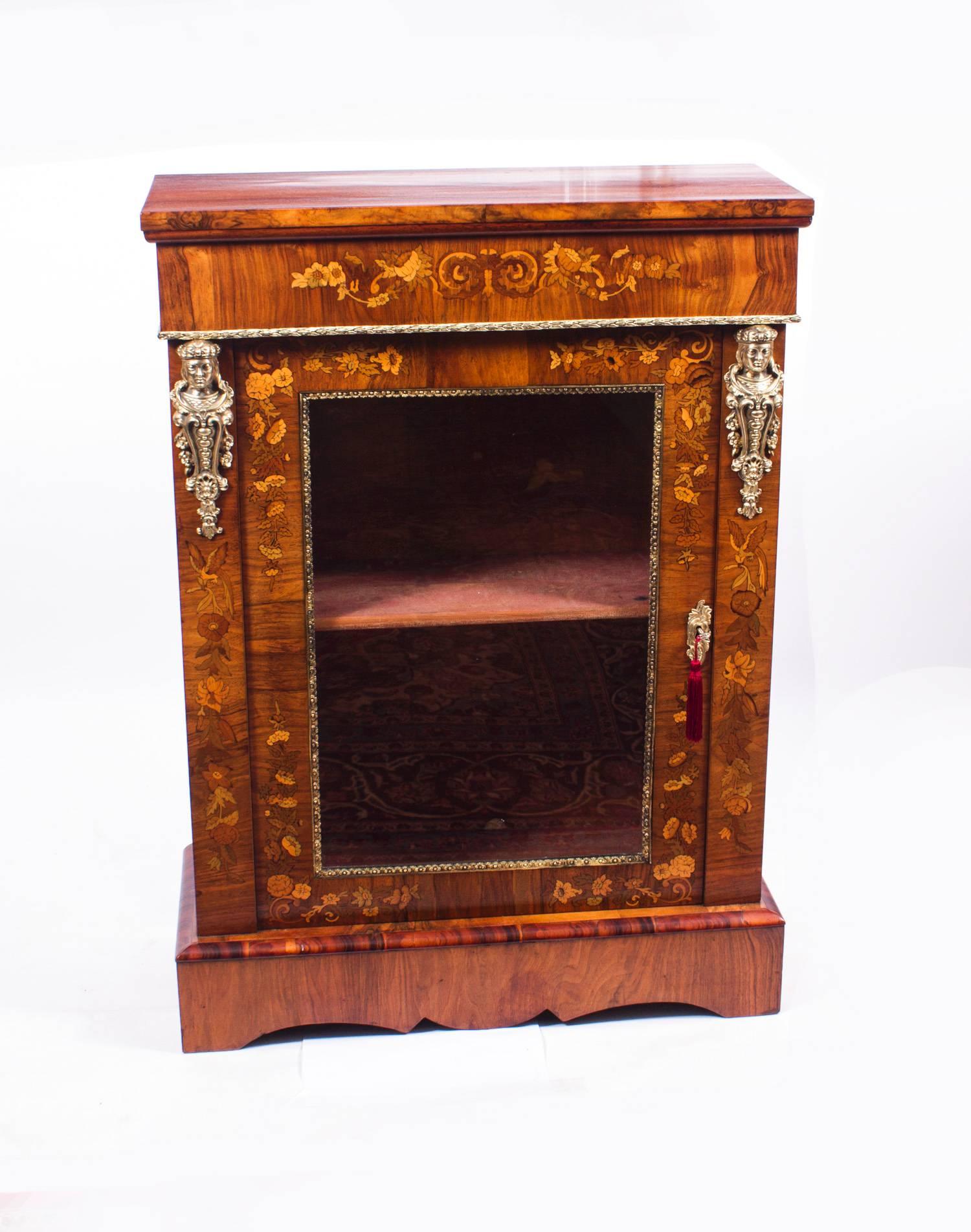 This is a magnificent antique pair of Victorian burr walnut and floral marquetry pier cabinets, circa 1870 in date.

They are a genuine pair - which can be confirmed by the fact that the doors open one to the left and one to the right.

Adding to