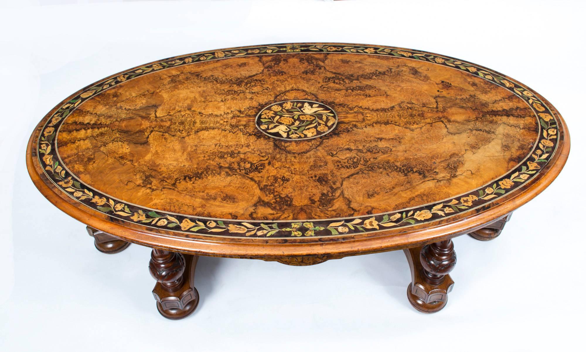 This is a superb Victorian burr walnut and marquetry oval coffee table, circa 1860 in date.

The table top is oval in shape and features wonderful burr walnut with a superb band of floral marquetry set in an ebony ground around the top with an