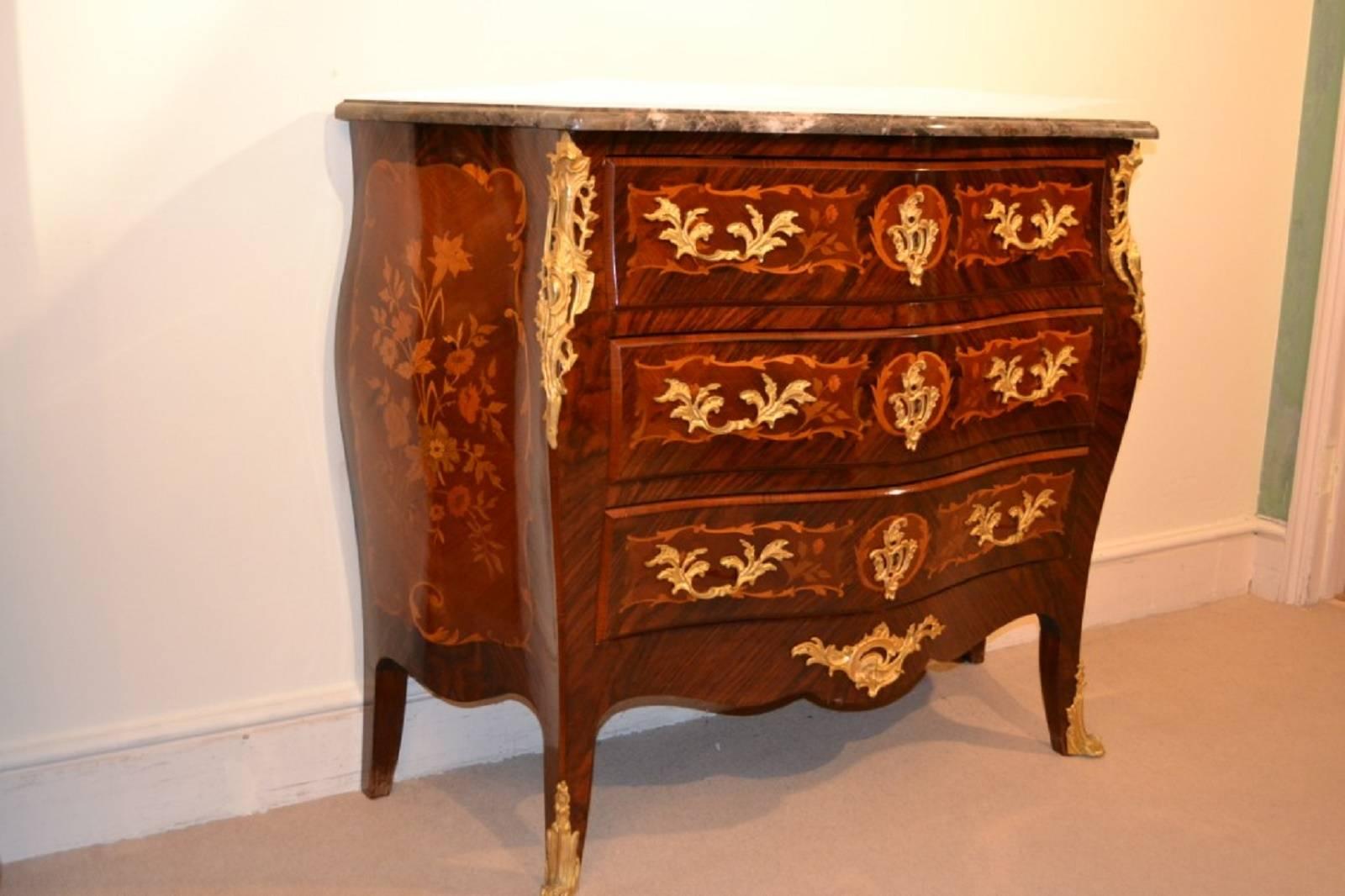This is a beautiful antique rosewood and fruitwood inlaid serpentine commode, circa 1880 in date and in the Louis XV manner. 

This gorgeous commode has three capacious drawers for ample storage and was inspired by the Louis XV style. Elaborately