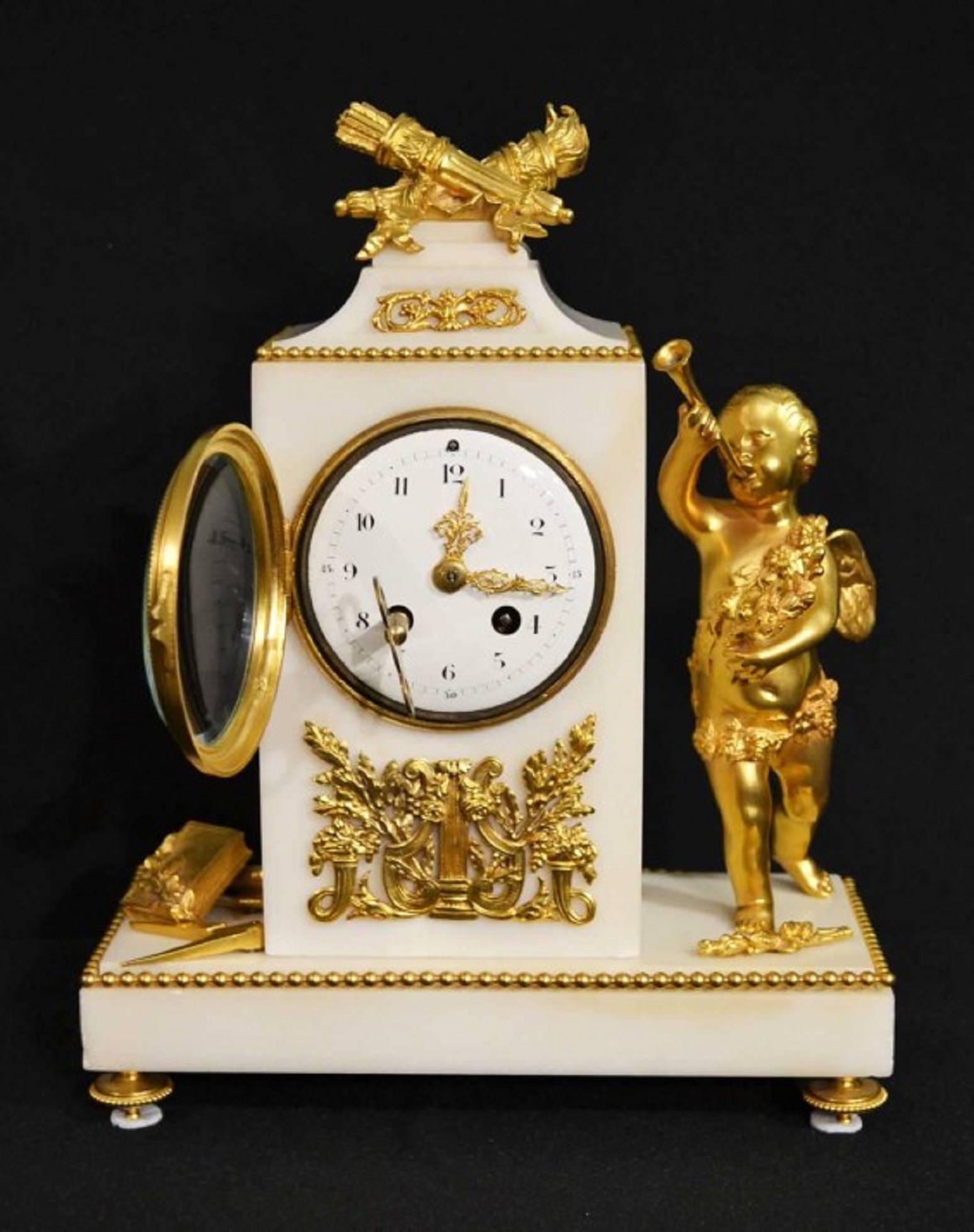 This is a fabulous white marble and ormolu mantel clock, circa 1850 in date.

This beautiful clock is surmounted by a flaming torch and quiver with arrows alongside a figure of Cupid blowing a horn. The other side has a compass and square which