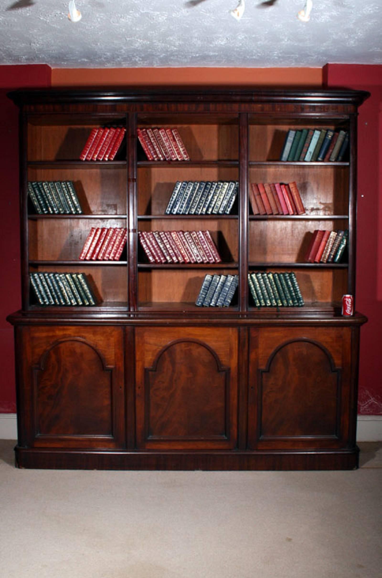 This is an antique Victorian mahogany open bookcase, circa 1850.

It has been masterfully crafted in a rich mahogany with adjustable shelves.

This upper section of this grand bookcase features three open sections with three sets of shelves each