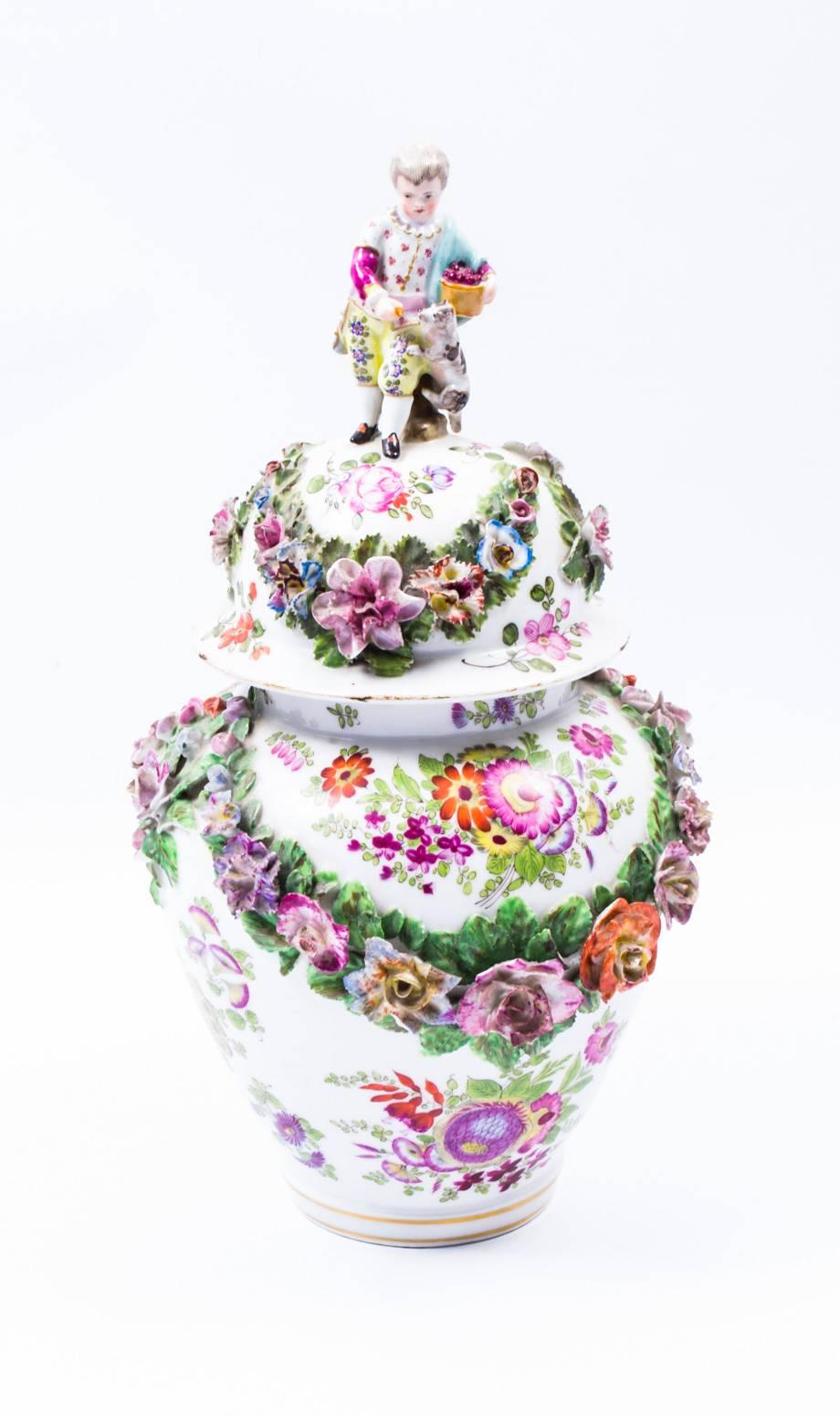 This is a beautiful pair of Meissen Porcelain vases and covers, circa 1880 in date.

Of baluster form each is encrusted with finely modelled and painted floral swags and sprays in high relief, with superb gilded highlights and hand-painted each