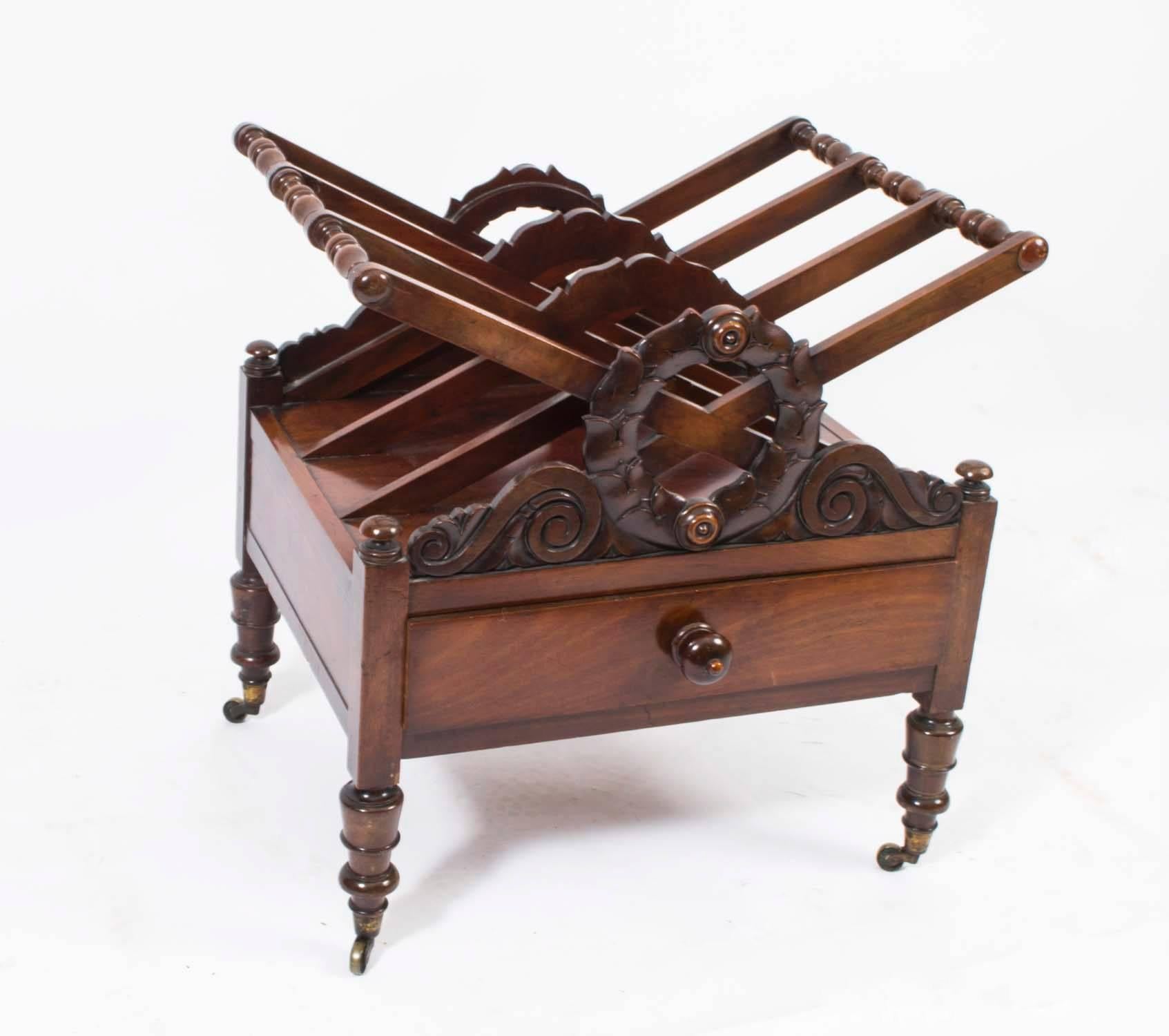 This is a gorgeous antique Regency mahogany Canterbury, circa 1820 in date.

The three sections are perfect for storing magazines and newspapers. It is beautifully decorated with carved floral scrolling ends above a useful drawer and it is elegantly