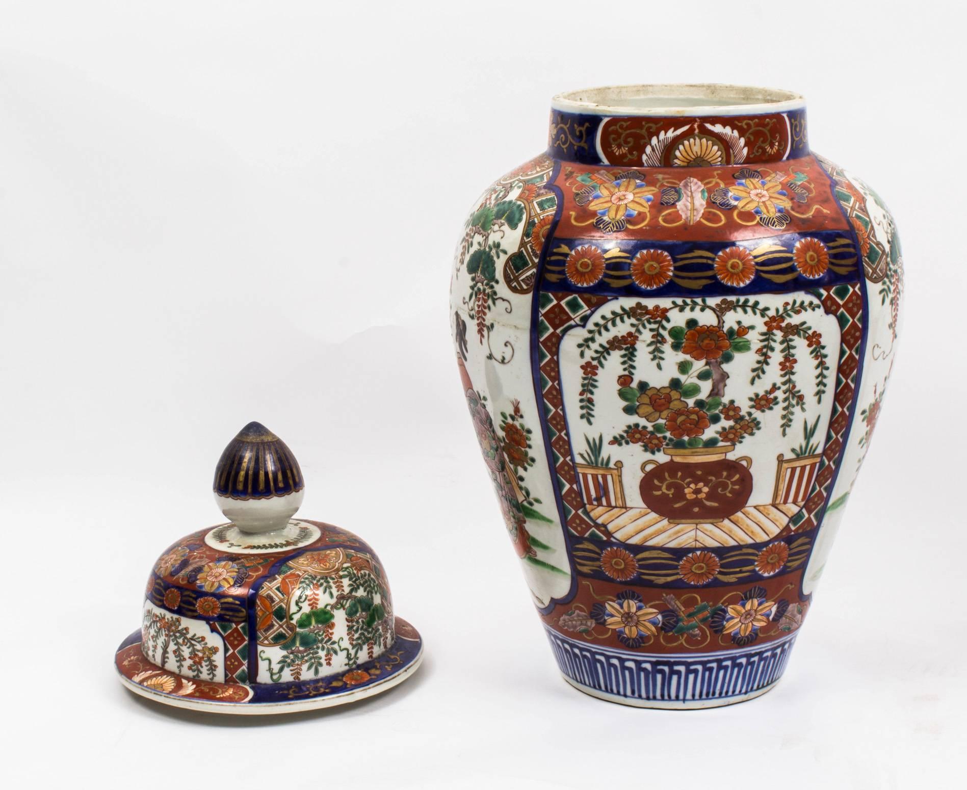 This is a lovely pair of Japanese Imari temple jars with lids, circa 1870 in date.

They feature a dense chrysanthemum floral based design with panels of geisha girls and attendants. The ground with flower heads and leaves, in the traditional
