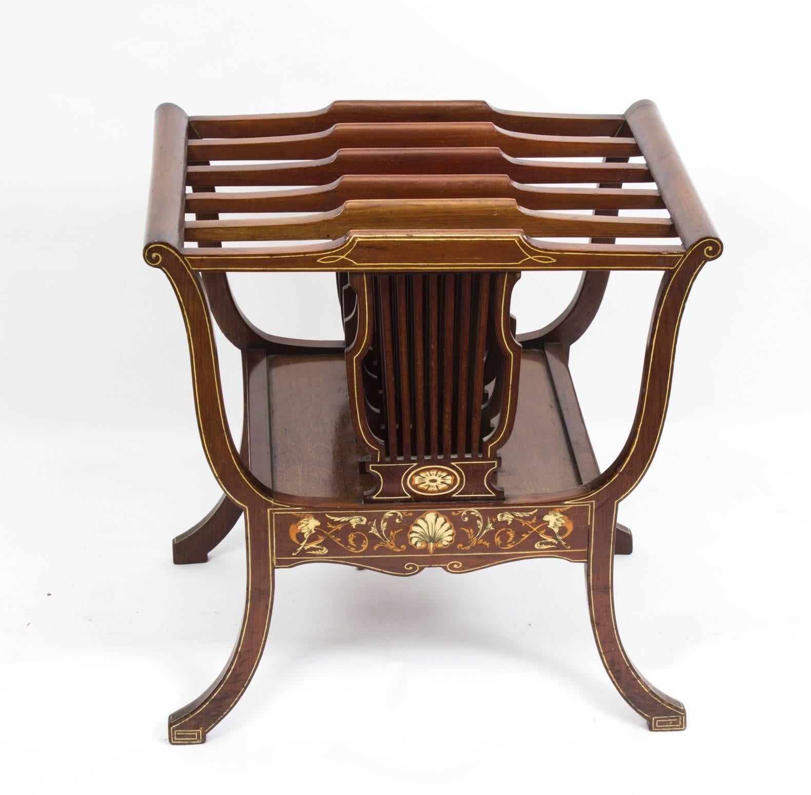 This is a gorgeous antique Edwardian mahogany Canterbury of lyre form with fabulous inlaid decoration, circa 1890 in date. 

It is beautifully oultined with stringing and scrolling foliate motifs, has five lyre shaped divisions and stands on elegant