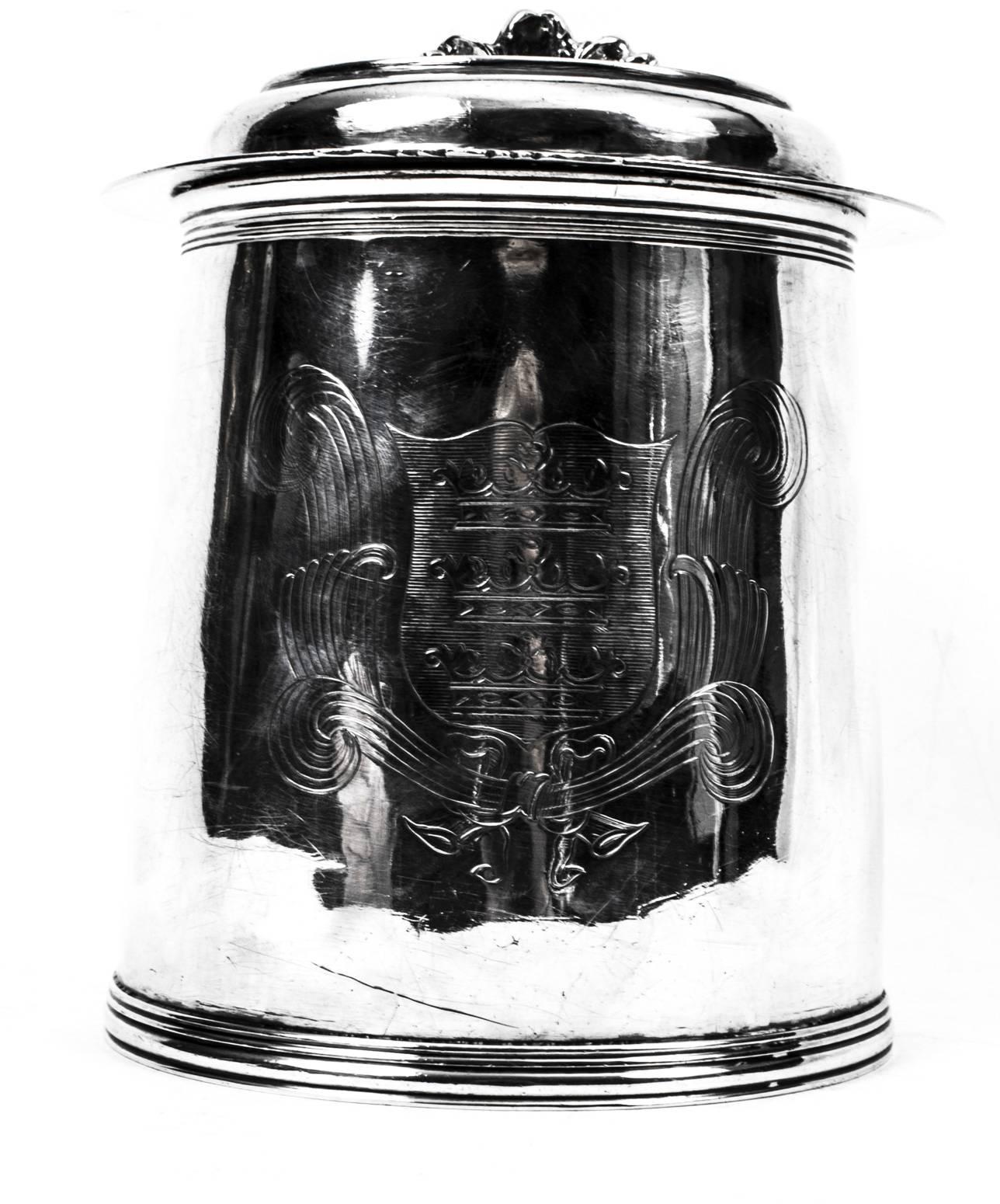 This is a wonderful antique silver Charles II lidded tankard with hall marks for London 1670, the makers mark T.R over a rosette and the Coat of Arms of the Borough of Kingston and Hull.
 
The tankard is of cylindrical form with moulded foot, the