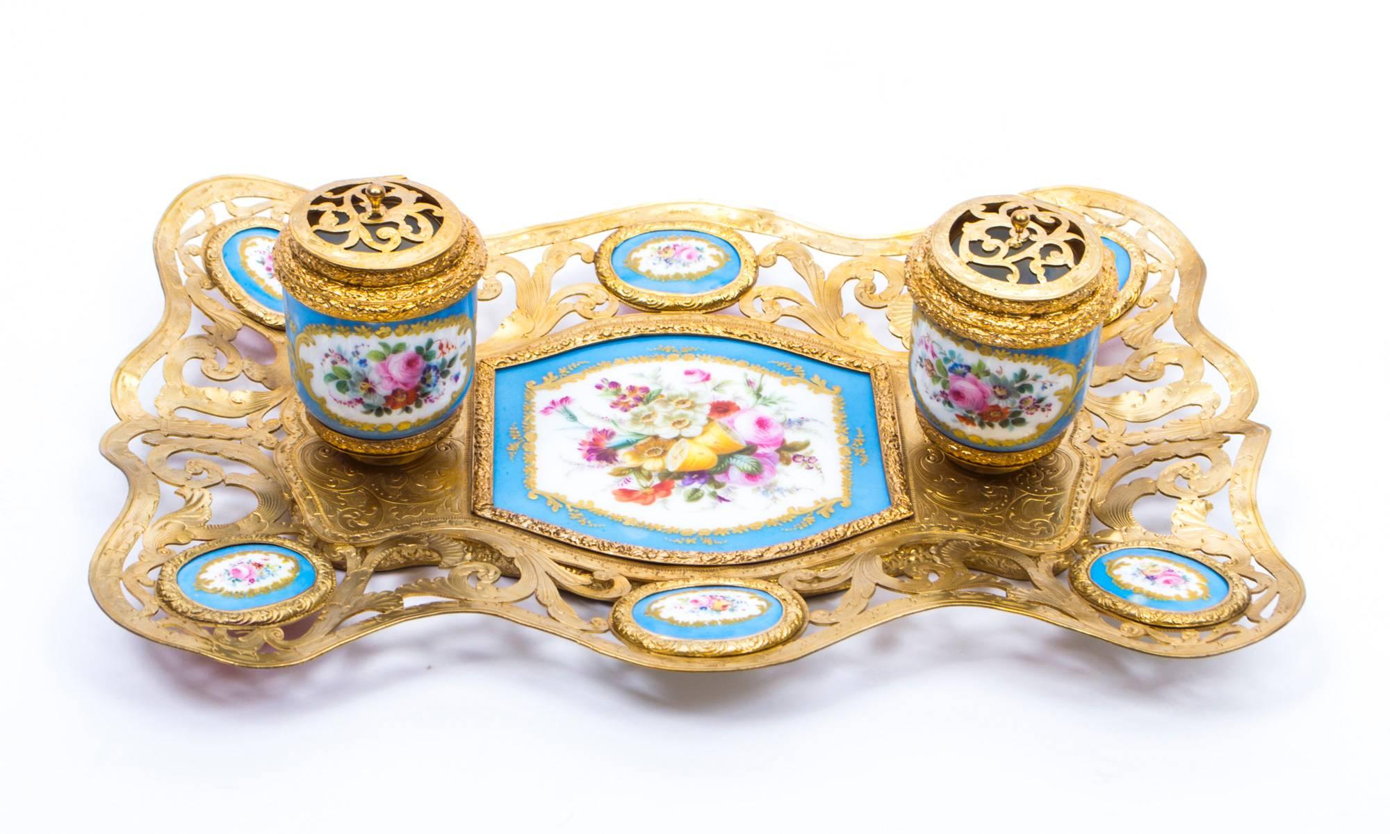 This is a wonderful antique French ormolu inkstand, mounted with Bleu Celeste Sèvres Porcelain panels that have been beautifully gilded and painted with floral bouquets, circa 1870 in date.

Of rectangular form with a pair of raised porcelain