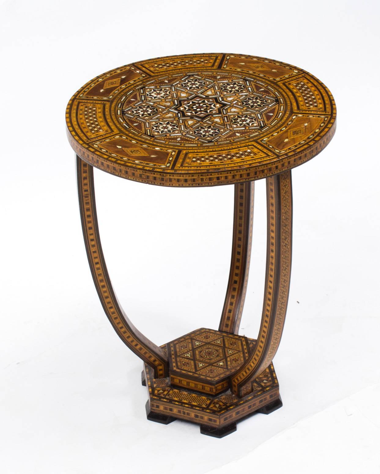 This is a beautiful antique Syrian hardwood inlaid occasional table, dating from the early 20th century.

The table is exquisitely handcrafted with beautiful geometric patterns.

It features wonderful inlaid decoration comprising ebony, walnut,