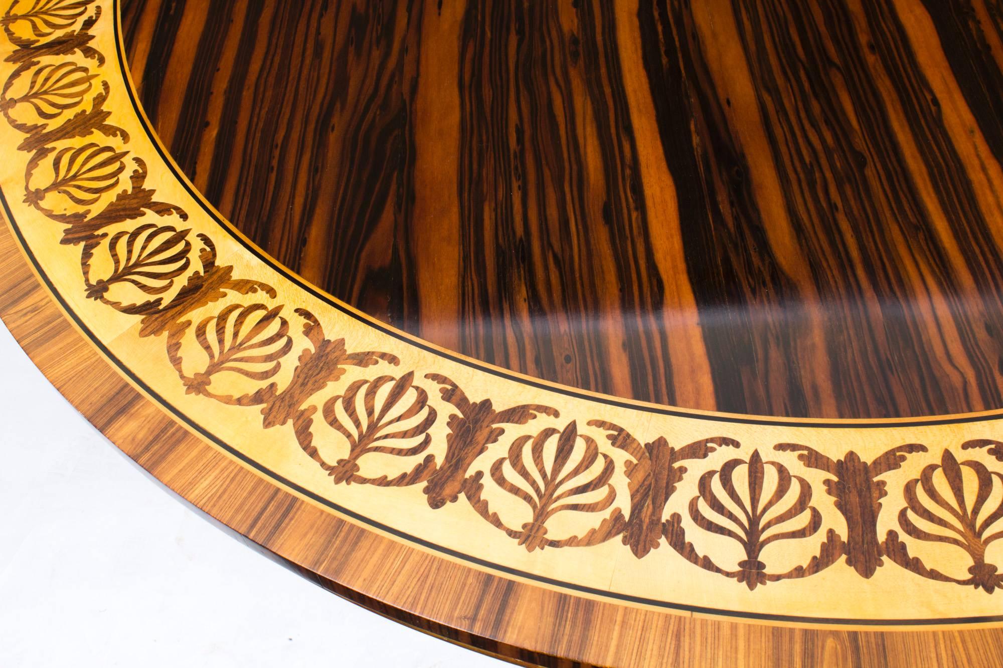 This is a stunning antique 5ft diameter calamander and parcel gilt circular breakfast table in the Regency manner, dating from the early 20th century.

The beautifully figured calamander top is inlaid with a wide satinwood and marquetry banding
