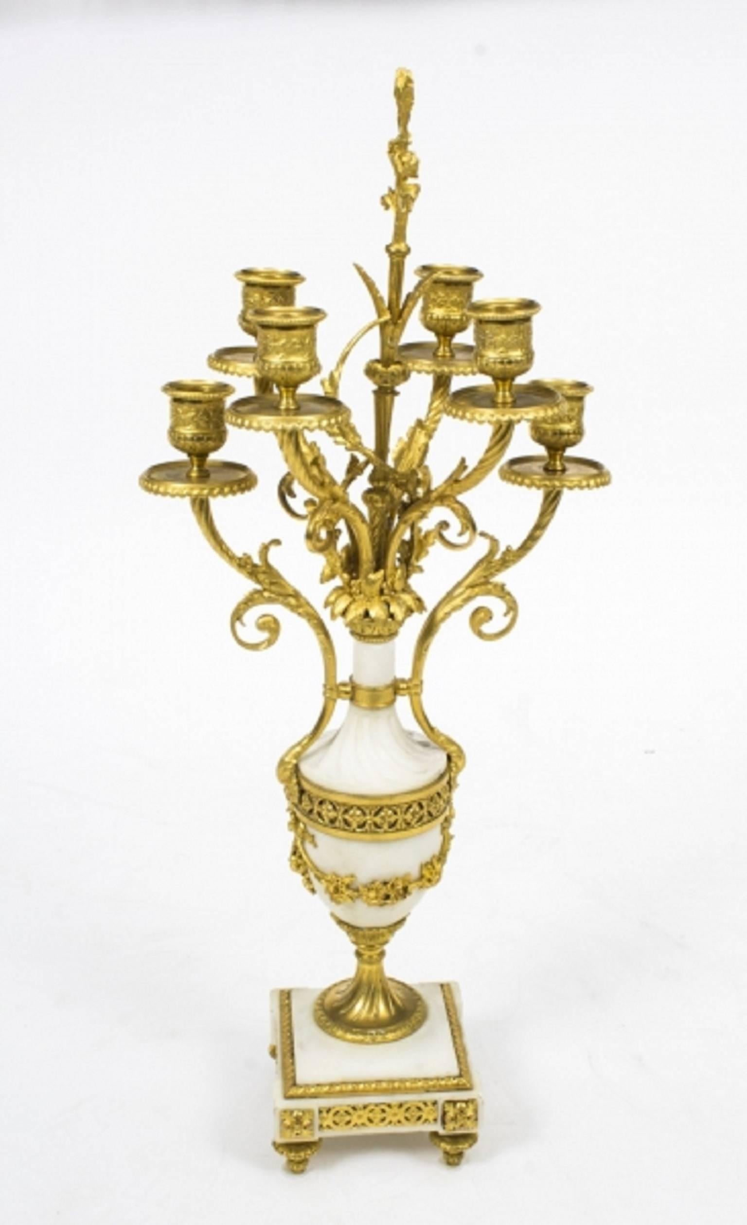 This is a stunning antique pair of Louis XV Revival ormolu and white "Carrara" marble six light, candelabra, circa 1870 in date.
 
This impressive pair have beautiful and intricate cast decoration of ribbons, bows, garlands, etc., have