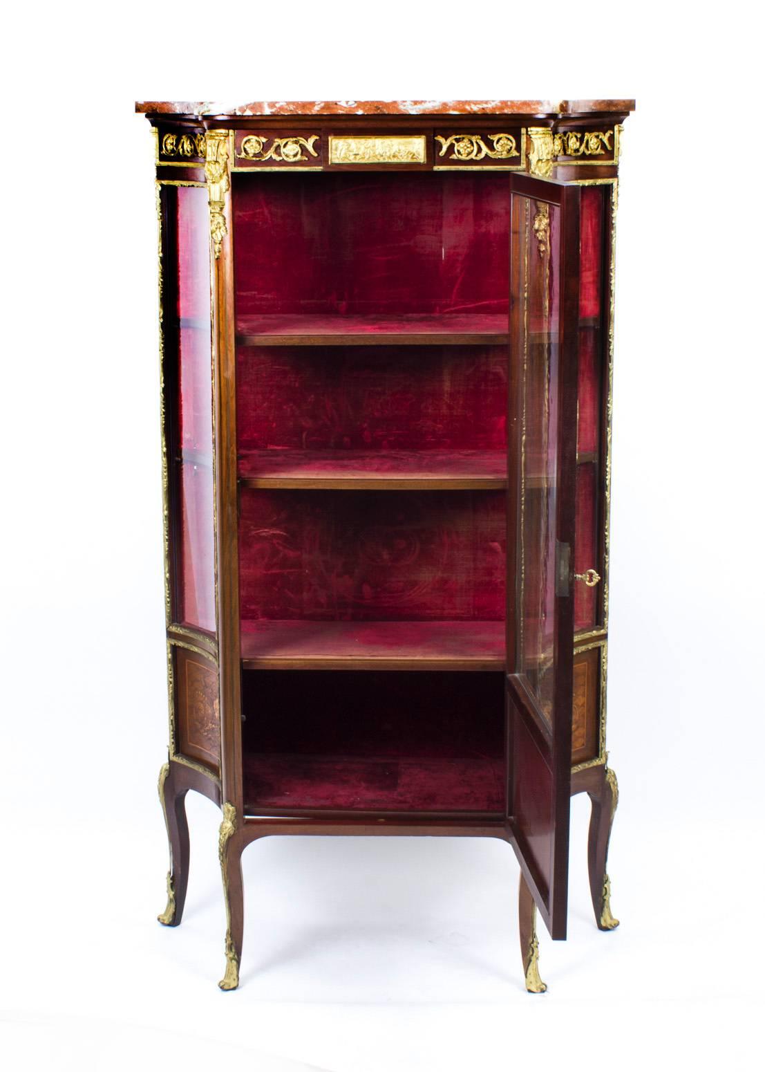 This is a stunning antique French mahogany and ormolu-mounted display cabinet in the French Louis XV manner, circa 1870 in date.

This beautiful cabinet has an abundance of exquisite ormolu mounts as well as intricate inlaid parquetry and marquetry