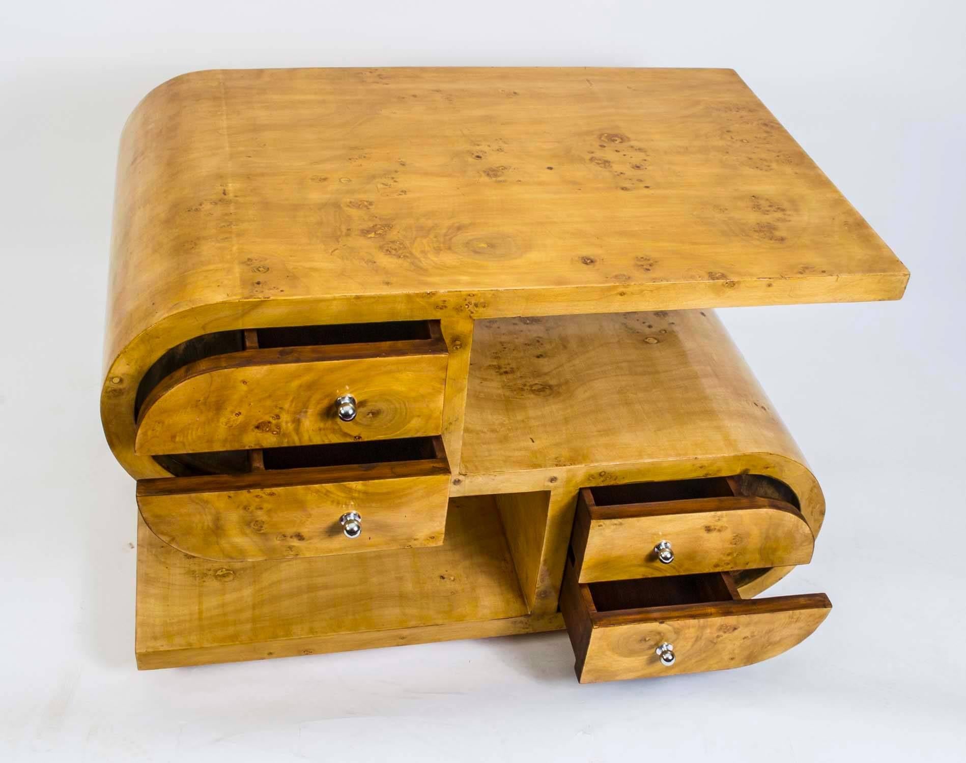 This is an unusual bird's-eye maple cabinet or side table in the fabulous Art Deco style from the last quarter of the 20th century.

This interesting piece is of unique 'S' shape form and features four unusually-shaped drawers on each side. The