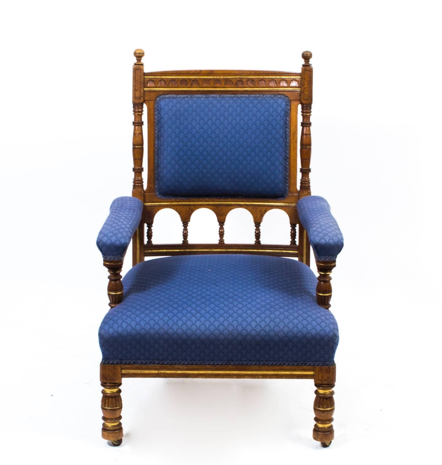 This is a wonderful antique oak armchair attributed to Bruce James Talbert, circa 1860 and manufactured by Gillows & Co. 

It is made of solid oak, has beautiful hand carved decoration and fabulous blue upholstery.

There is no mistaking the