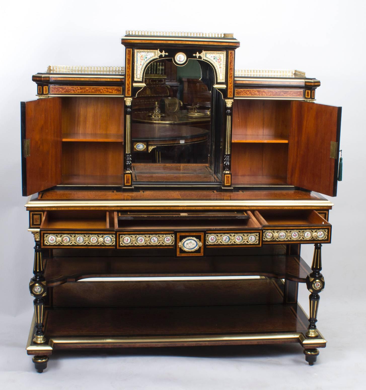 This is a gorgeous Victorian amboyna, ebonised and ormolu-mounted Bonheur Du Jour or ladies writing desk, circa 1860 in date.

Surmounted by decorative pierced brass galleries, it is made from amboyna and the rare thuya wood, the whole decorated