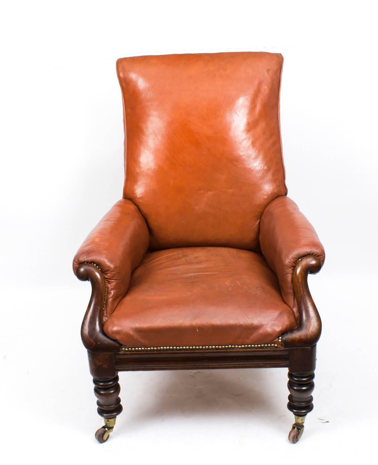 This is a superb William IV brown leather upholstered armchair, circa 1830 in date.

The chair has a square frame and mahogany scroll arm supports. It is raised on turned legs that terminate with their original brass and porcelain castors.

It