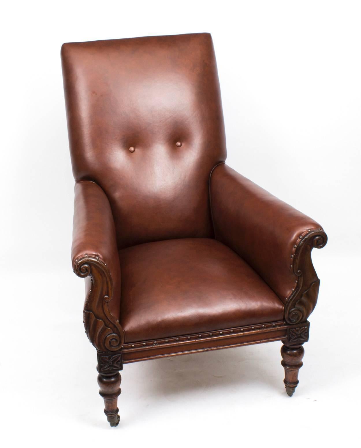 This is an elegant antique William IV mahogany framed library armchair, circa 1830 in date.

The rectangular back and spring seat covered in a brown hide with outscrolling arms and baluster turned legs that terminate in their original brass and