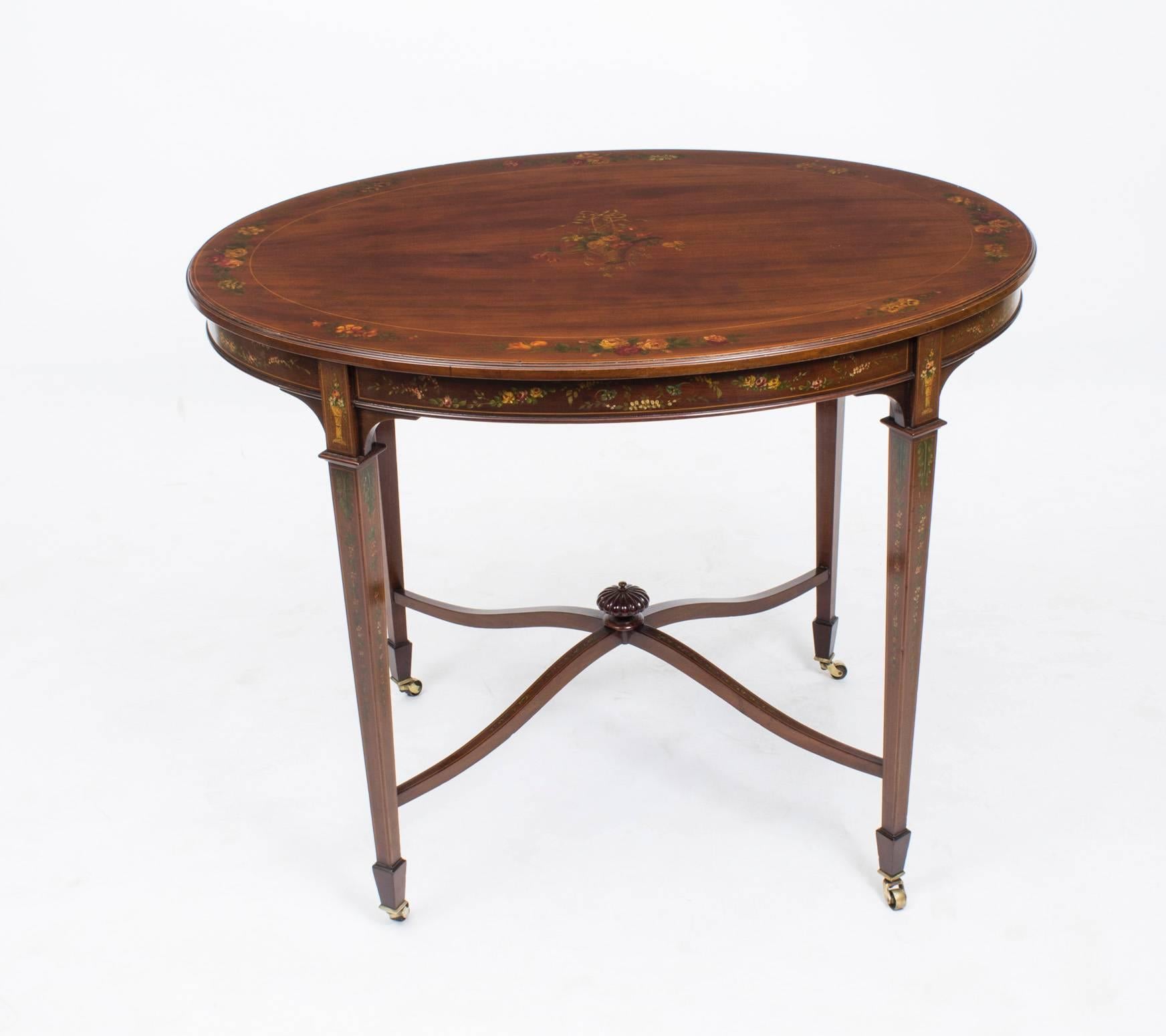 A truly exceptional Antique English Edwardian oval mahogany occasional table circa 1890 in date.

Crafted from flame mahogany note the wonderful grain to the wood, and beautifully hand-painted,with floral sprays, garlands with string inlaid