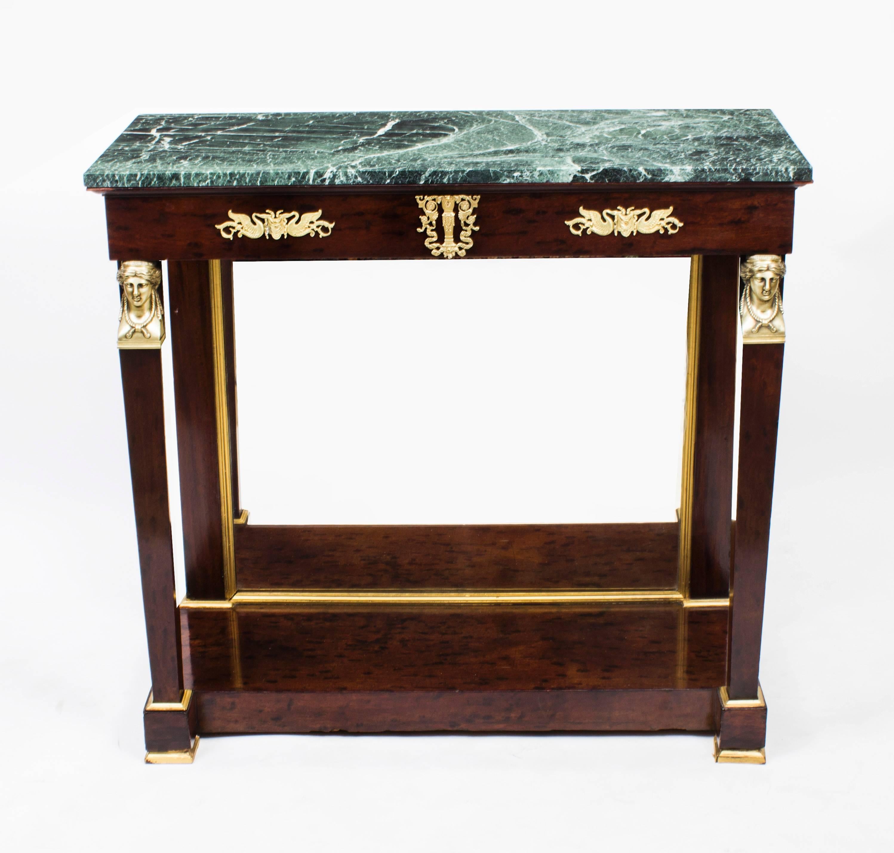 This is a beautiful antique French Empire flame mahogany and ormolu-mounted console table with a striking Verde Antico green marble-top, circa 1810 in date.

The table has wonderful decorative ormolu classical sphynx heads above each front leg. It