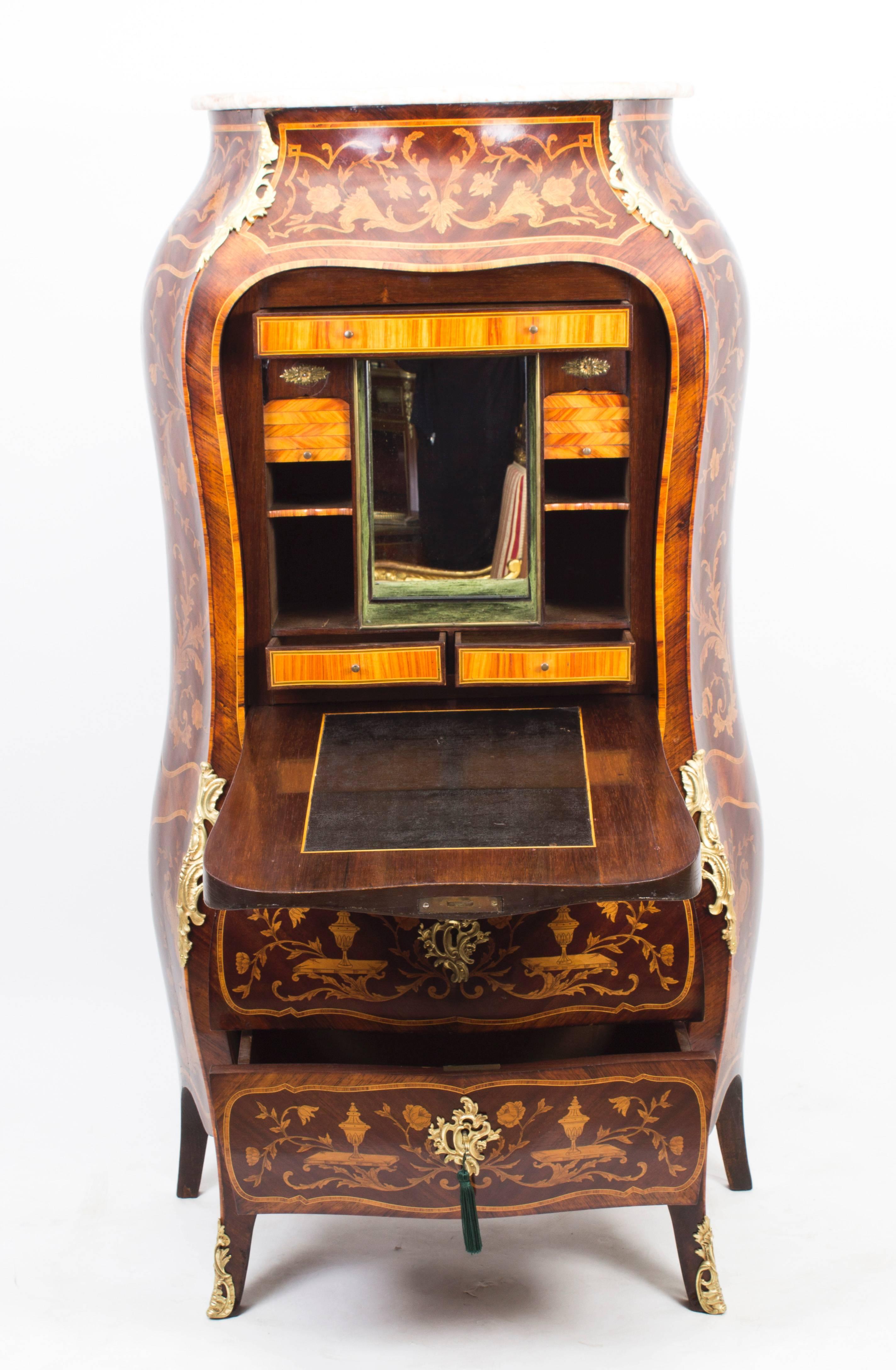 Dating from around 1850, this is a wonderful antique French Rococo Revival Secretaire a Abattant featuring ormolu mounted mahogany, gonzalo alves and marquetry.

A Secretaire a abattant is a tall French writing-desk, the top part of which resembles