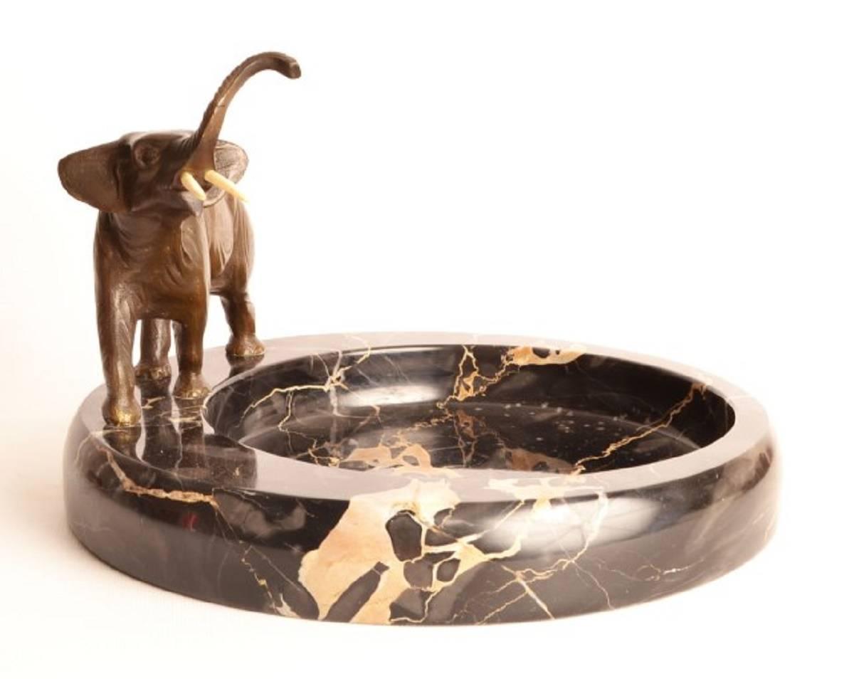 This is an antique bronze sculpture of a distinguished old elephant with fabulous tusks set on an attractive marble base, circa 1920.

This high quality bronze was produced using the traditional 'lost wax' process.

It can be used as a bowl, an