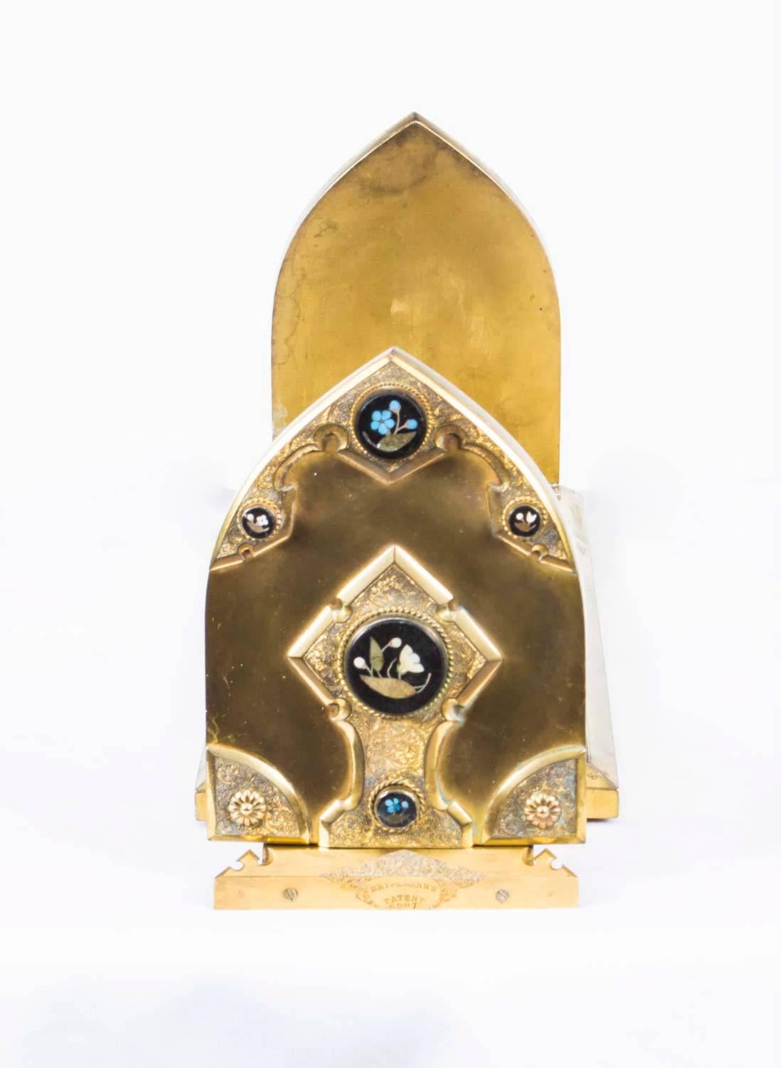 This is a wonderful 19th century Victorian Gothic Revival ormolu self closing book slide with fabulous Pietra Dura decoration of Derbyshire black slate inlaid with semi precious gemstones in floral pattern, circa 1870 in date.

The underside bears