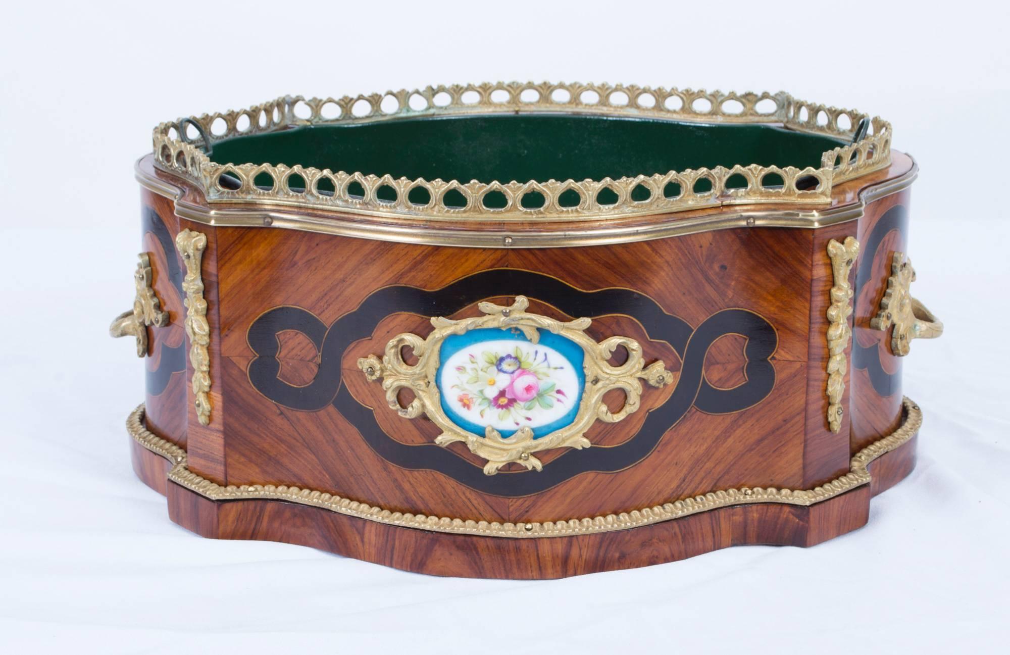 This is a beautiful antique French ormolu and Sevres porcelain mounted, kingwood jardiniere, circa 1870.

The jardiniere is serpentine in shape with ormolu mounts enclosing enchanting floral hand painted Sevres porcelain plaques, ebonised banding
