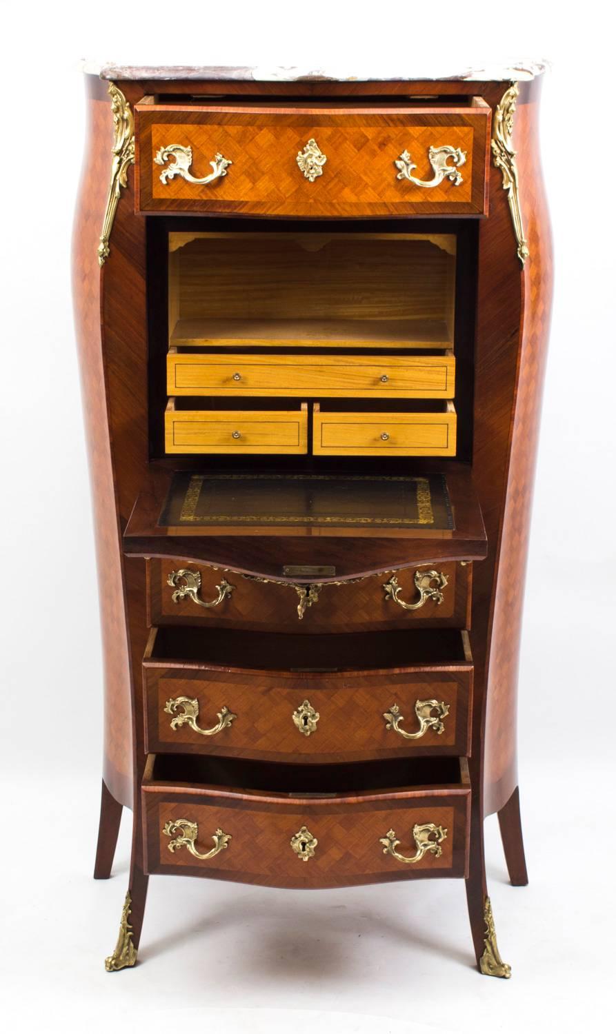This is an antique French Vernis Martin gonzalo alves and kingwood bombe shaped secretaire cabinet dating from around 1880.

The fall front of this antique secretaire is decorated with a vignette of a courting couple set within an extravagant ormolu