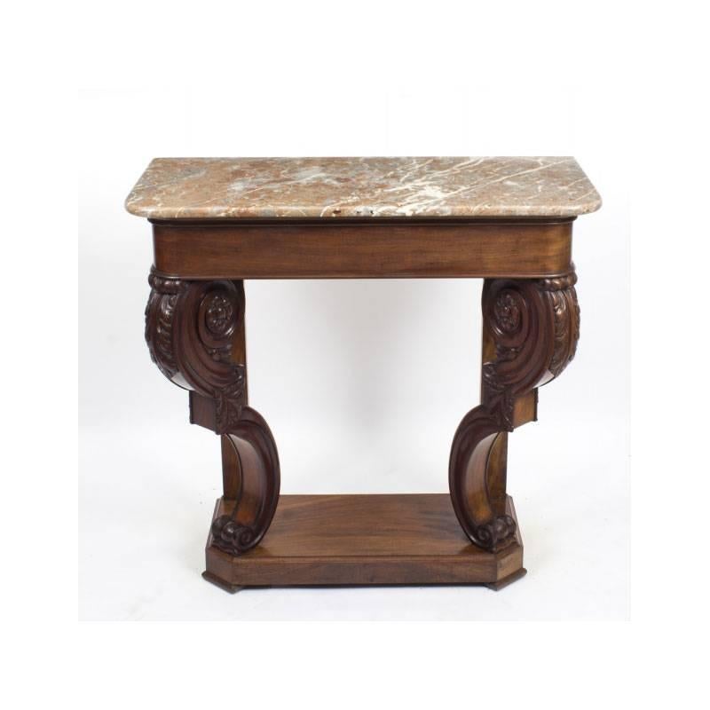 A superb William IV marble topped console table, circa 1835 in date.

It has a beautiful rouge variegated patterned marble top above a superb quality frieze. The front legs with carved scroll supports and finely carved with rosettes and foliate