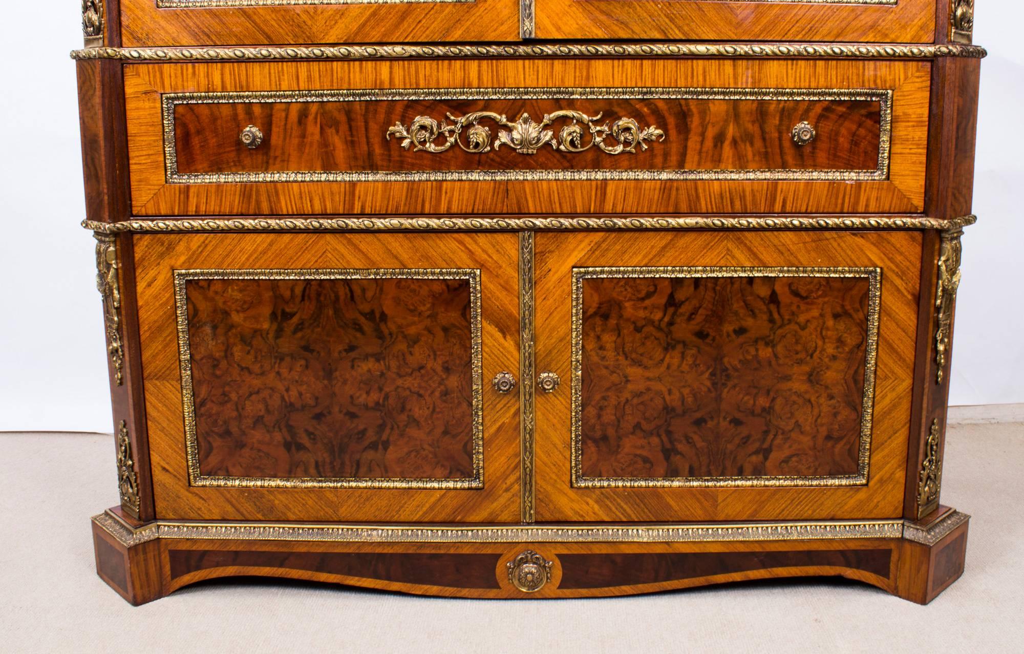 This is a superb large French Louis XV revival burr walnut and kingwood ormolu-mounted cocktail cabinet, mid-20th century in date. 

Adding to its truly unique character it has been decorated with a plethora of exquisite gilded ormolu