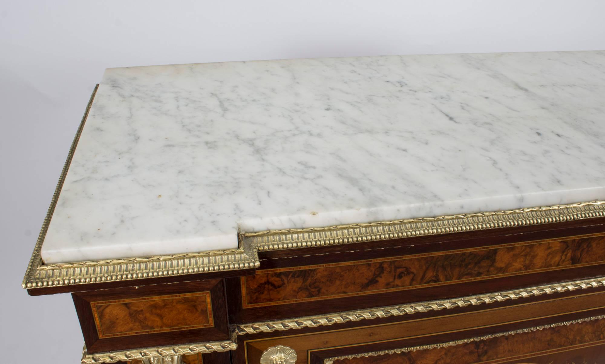 This is a beautiful antique French Napoleon III burr walnut and ormolu-mounted marquetry side cabinet, with a beautiful Carrara marble top, in the grand Louis XV style, circa 1860 in date.

It is made of burr walnut and mahogany with a beautiful