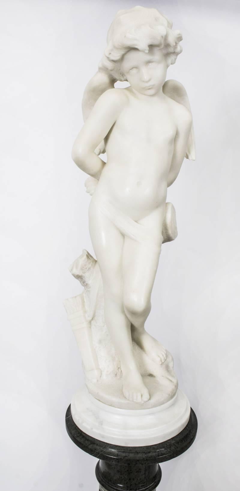 A lovely French marble sculpture by Denise Delavigne titled "Les Liens De L'amour", which translates as Cupid Bound, raised on it's original Serpentine marble pedestal, circa 1890 in date.

The beautiful sculpture is made from stunning