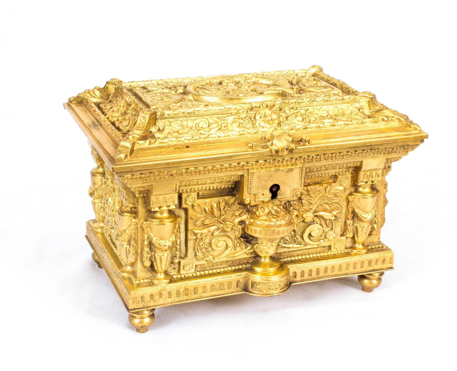 This is a beautiful antique French Renaissance Revival gilded ormolu Palais Royale jewellery casket, circa 1870 in date.

The top, front, sides and back are beautifully cast in gilt bronze with bows, ribbons, garlands, urns and cherubs and it