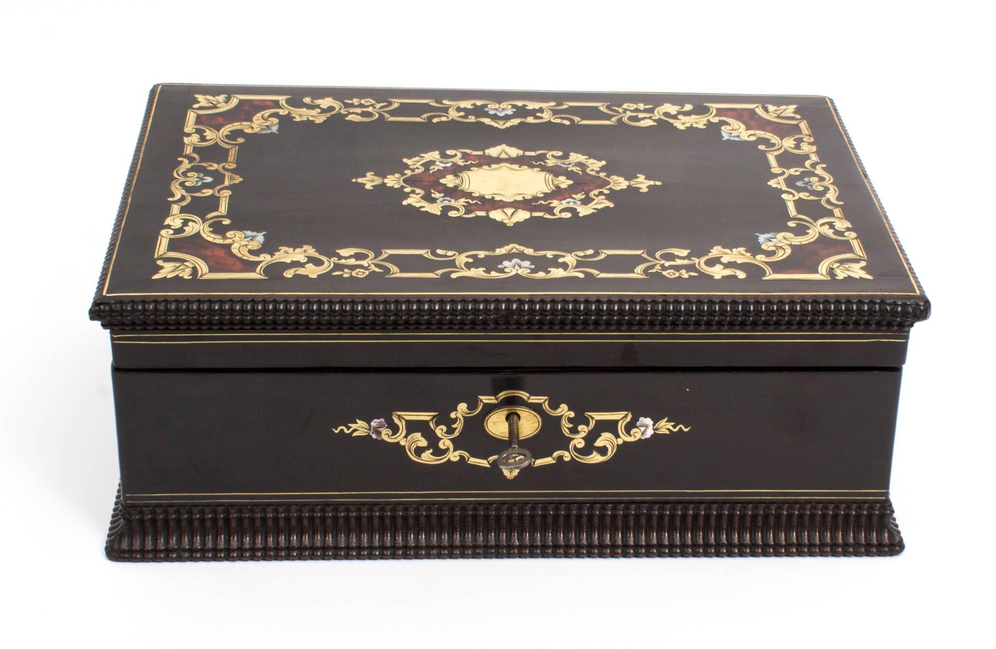 This is a beautiful antique French ebonized mother-of-pearl and cut brass red “Boulle” jewelry box, circa 1860 in date.

The lid and base have been edged with attractive beaded decoration and the top and front extensively inlaid with brass and