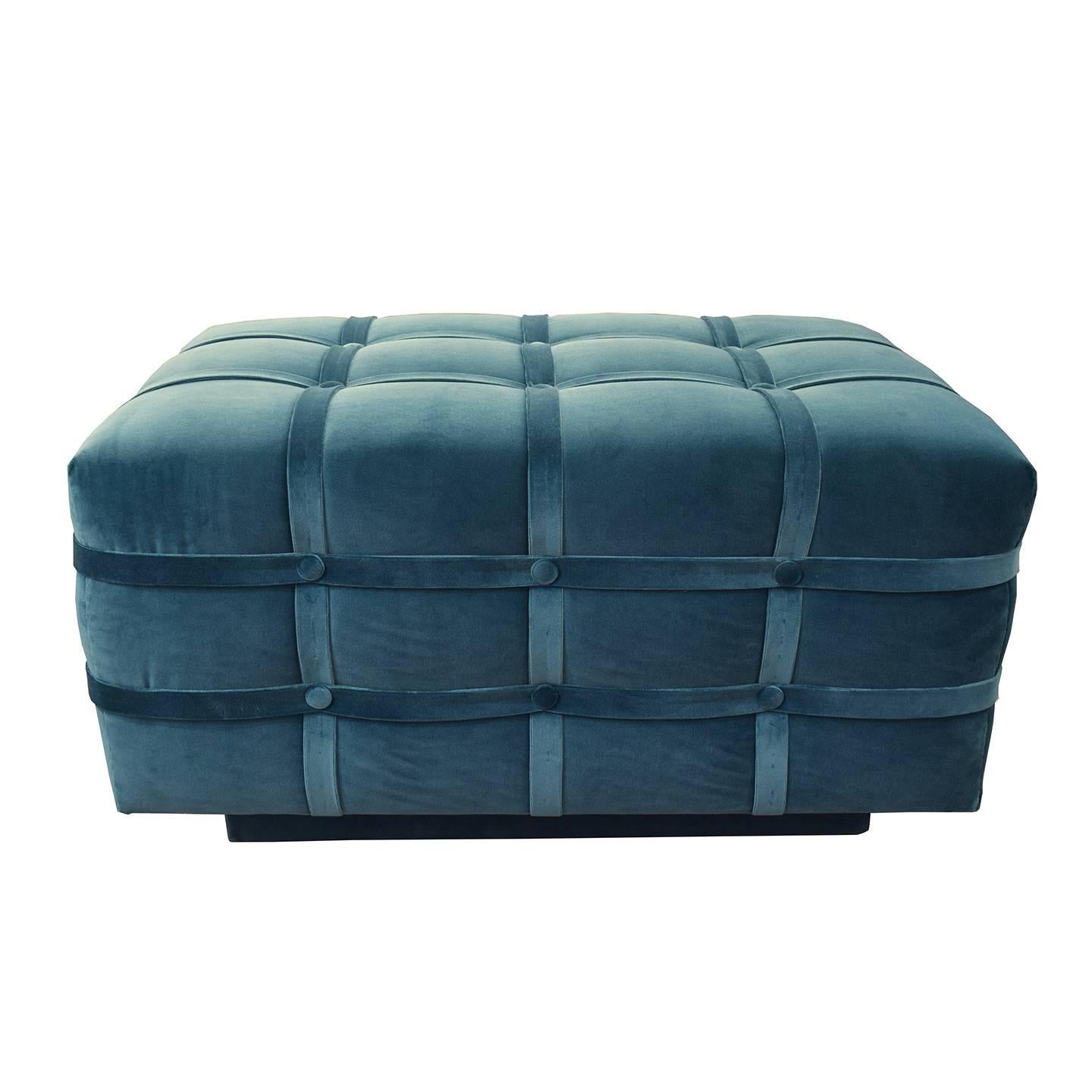 The Soho Strapped Ottoman, designed by Irwin Feld Design for CF MODERN, makes a gentle statement in a soft velvet upholstery. The cushion is wrapped in five intersecting straps and adorned with covered buttons that create a tufted effect. The Soho