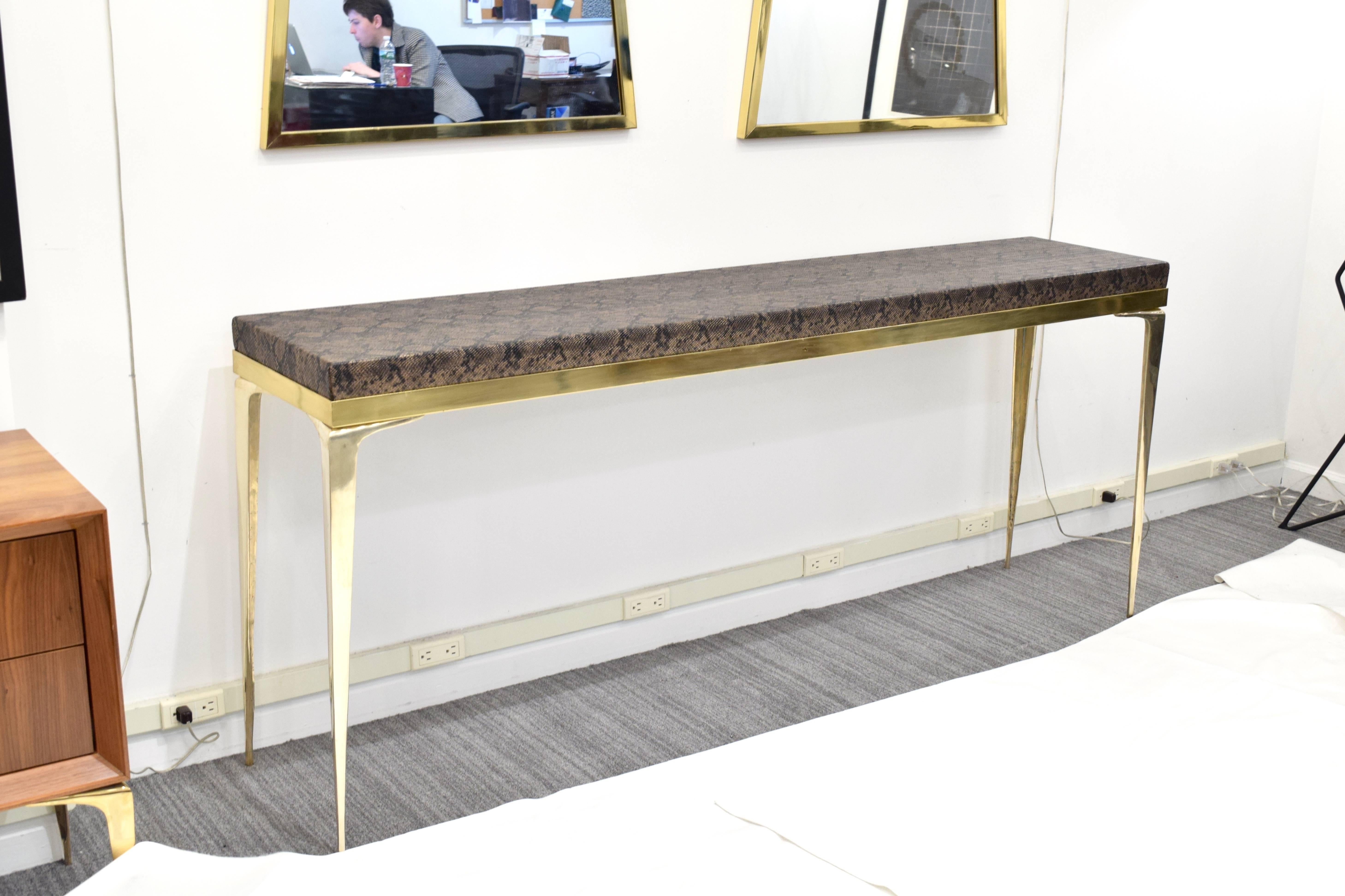 Gorgeous python upholstered top Stiletto console by Irwin Feld Design for CF Modern. Fabricated in the USA, customized to your perfect specifications. Shown with a gorgeous python top, polished brass frame, hand cast and polished brass 