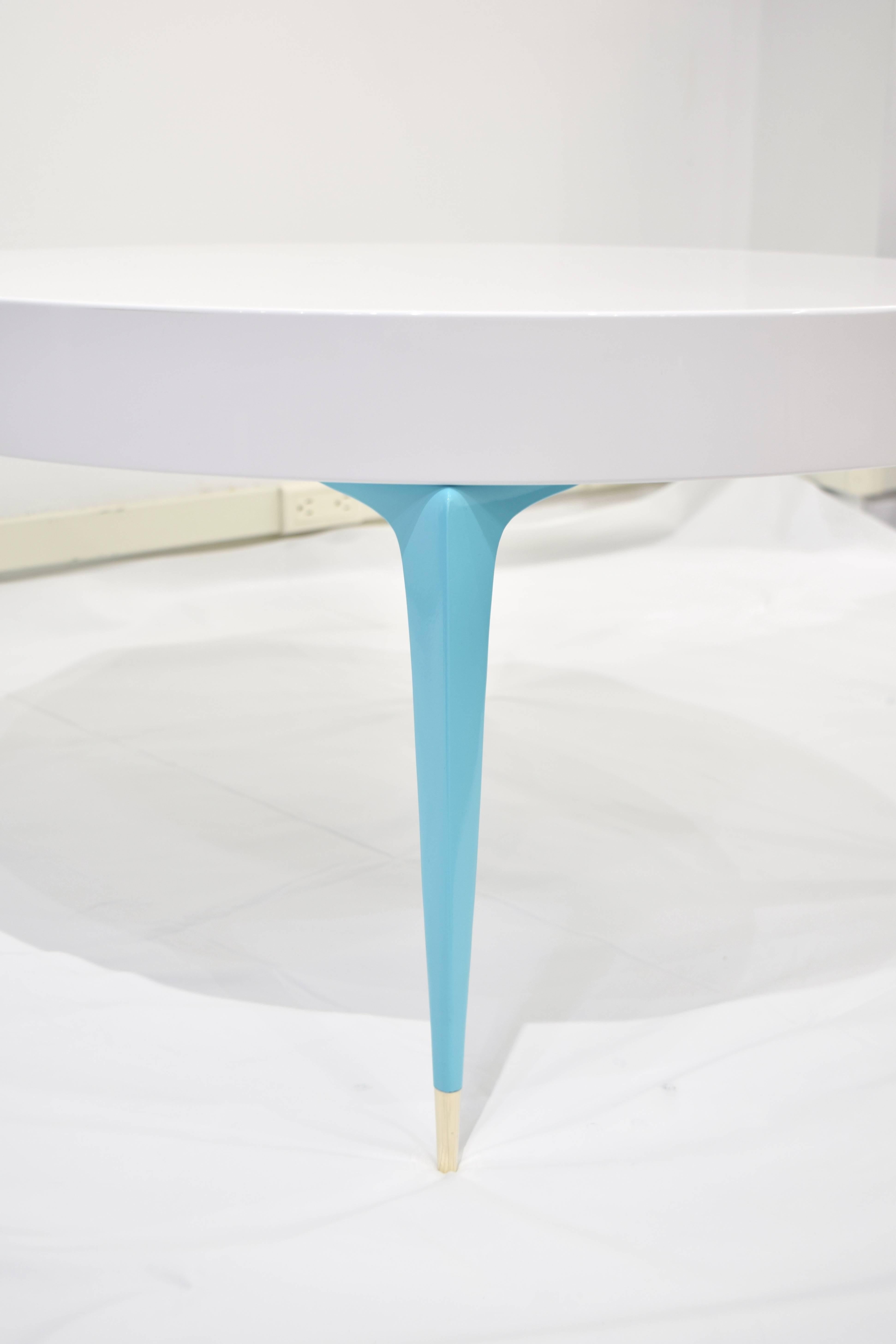 A playfully elegant Electra coffee table designed by Irwin Feld Design for CF Modern apart of our fully customizable Stiletto Collection. A high-gloss, white lacquered top set atop four powder-coated brass in Tiffany blue 