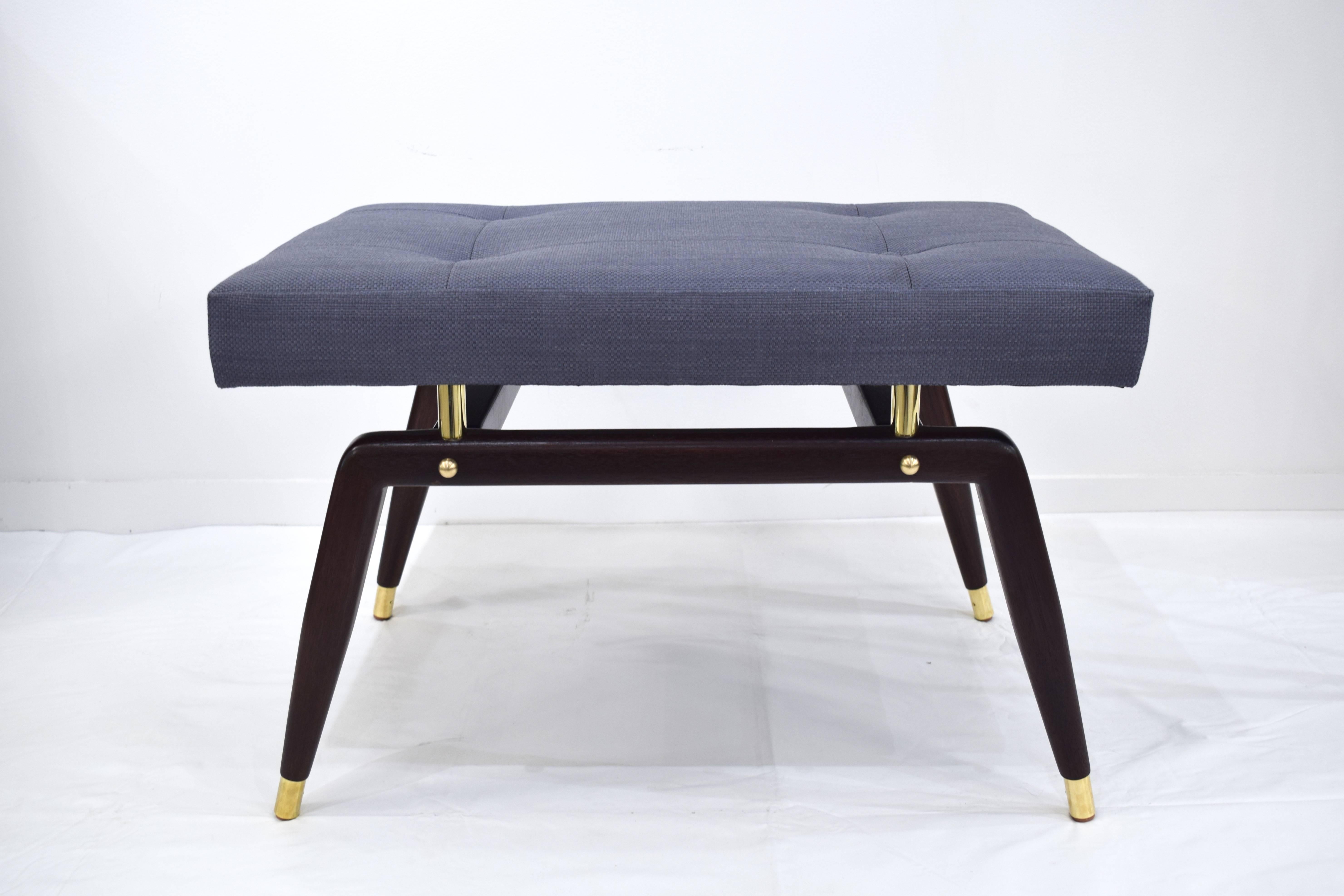 This elegantly appointed custom Formation ottoman is designed by Irwin Feld Design for CF Modern. Boasting clean and sculptural lines, the semi-gloss dark walnut base has custom brass sabots, risers and finials. Shown here in a Steel Blue Holly Hunt