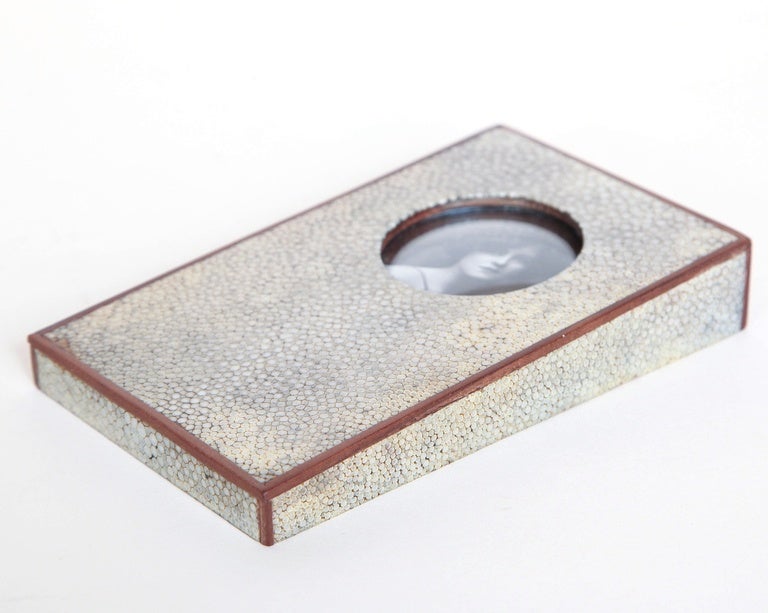 In wedge shape of paper weight with circular small picture frame and wood banding around the top and sides.

(Price shown is reduced price, no further trade discount) 