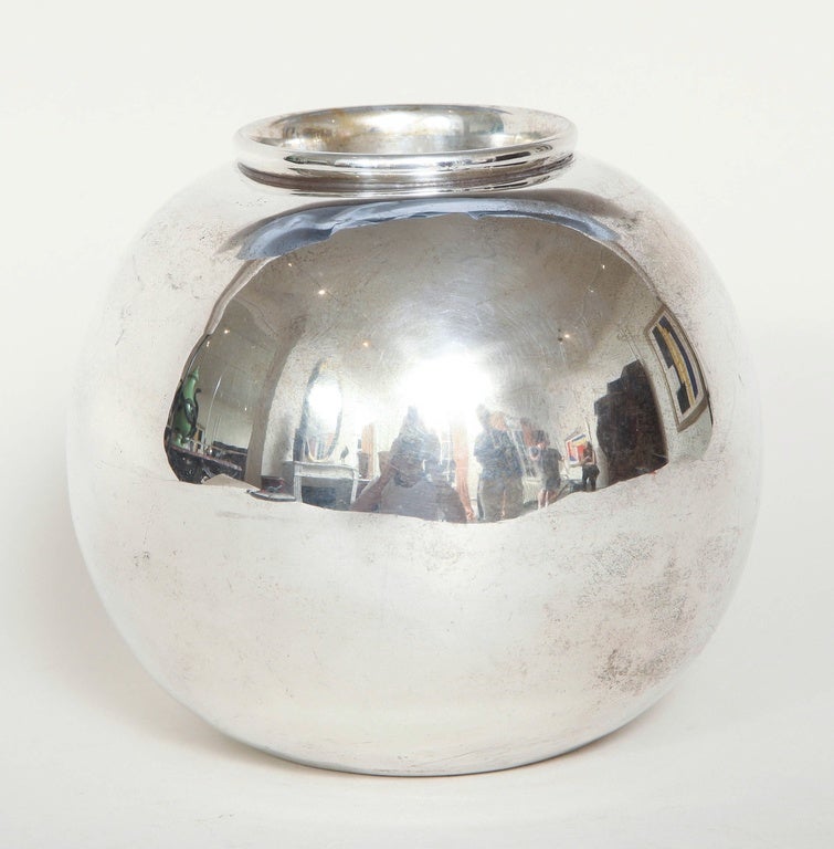 This spherical metal argente vase has a circular ring around the mouth.

Signed: DIM underneath