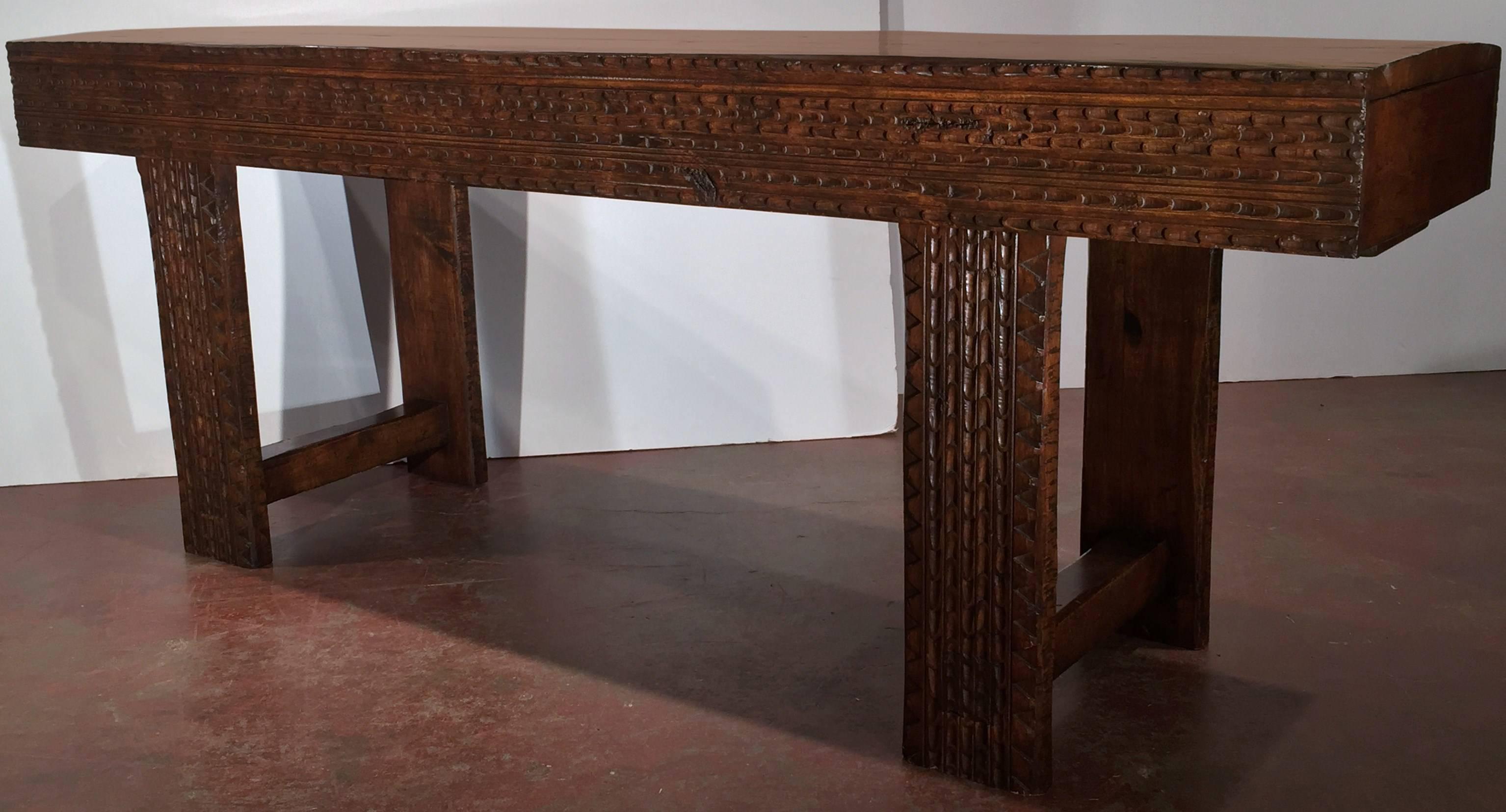 Rustic carved walnut sofa table from the French Pyrenees. This piece, carved on both sides with a drawer at each end, has great patina and character. A great addition for a contemporary home or a very traditional ranch!