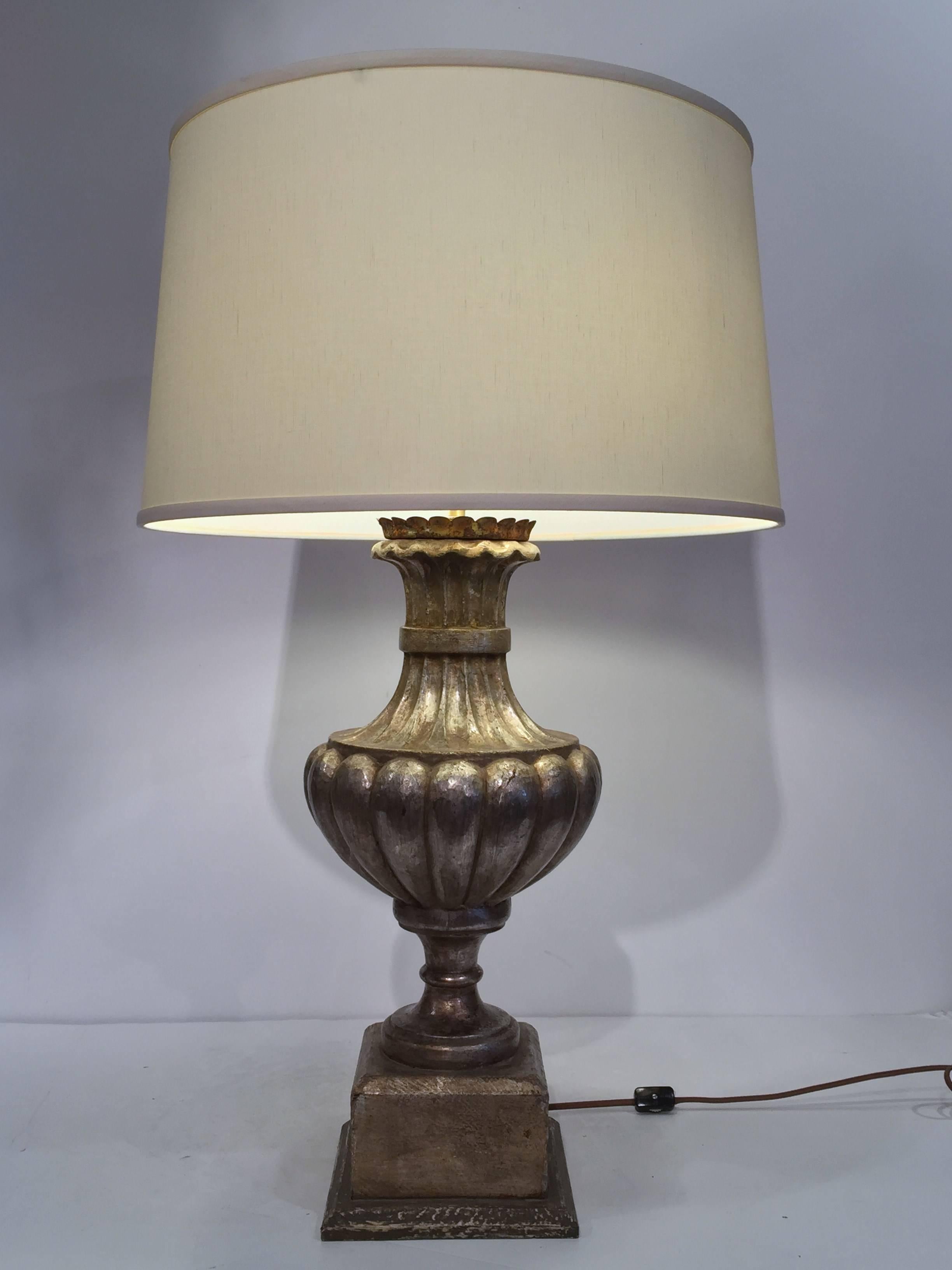 This pair of wooden vase lamp bases were crafted in Italy with metallic silver leaf finish. The bases are carved in the shape of classical urns and have new wiring with double sockets bulbs. Place the lamp bases in a living room or on bedside