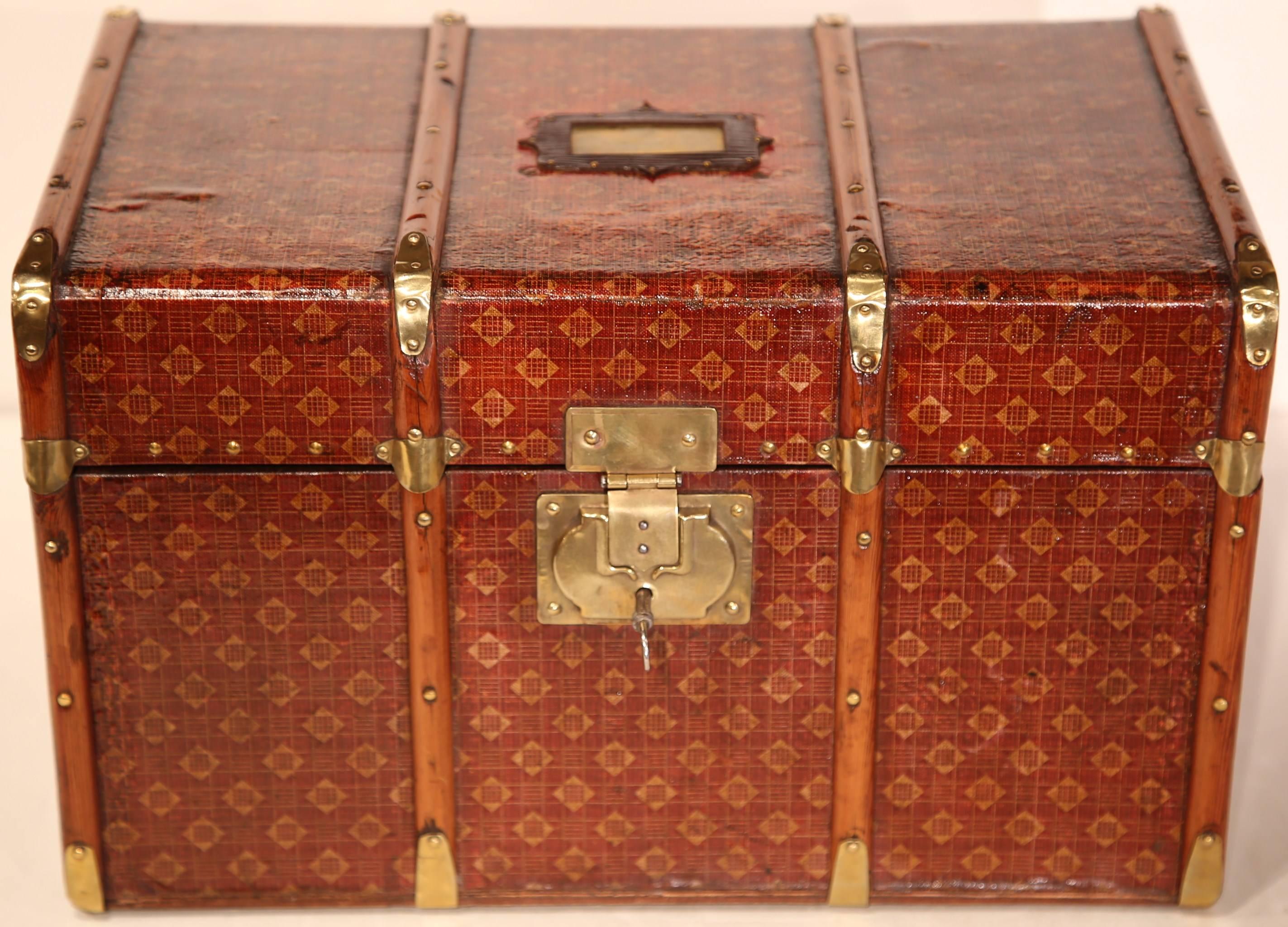 Stow your jewelry and other treasures inside this elegant, antique wooden box. Crafted in France, circa 1880, this decorative trunk is covered with leather, has wood trim and is studded with brass hardware and lock mechanism. Similar to a Louis