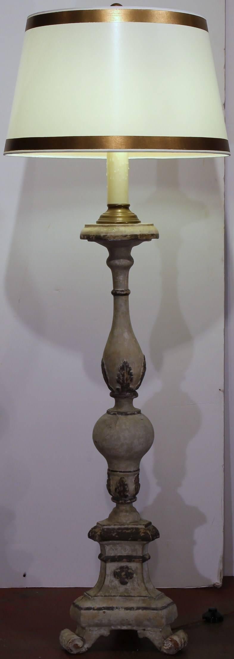 This pair of tall, antique wooden candlesticks from Italy, were converted into lamps, circa 1790. Each of the 18th century altar sticks has been rewired with custom wax candle and is sold with a custom white and gold shade. The base of the lamp has