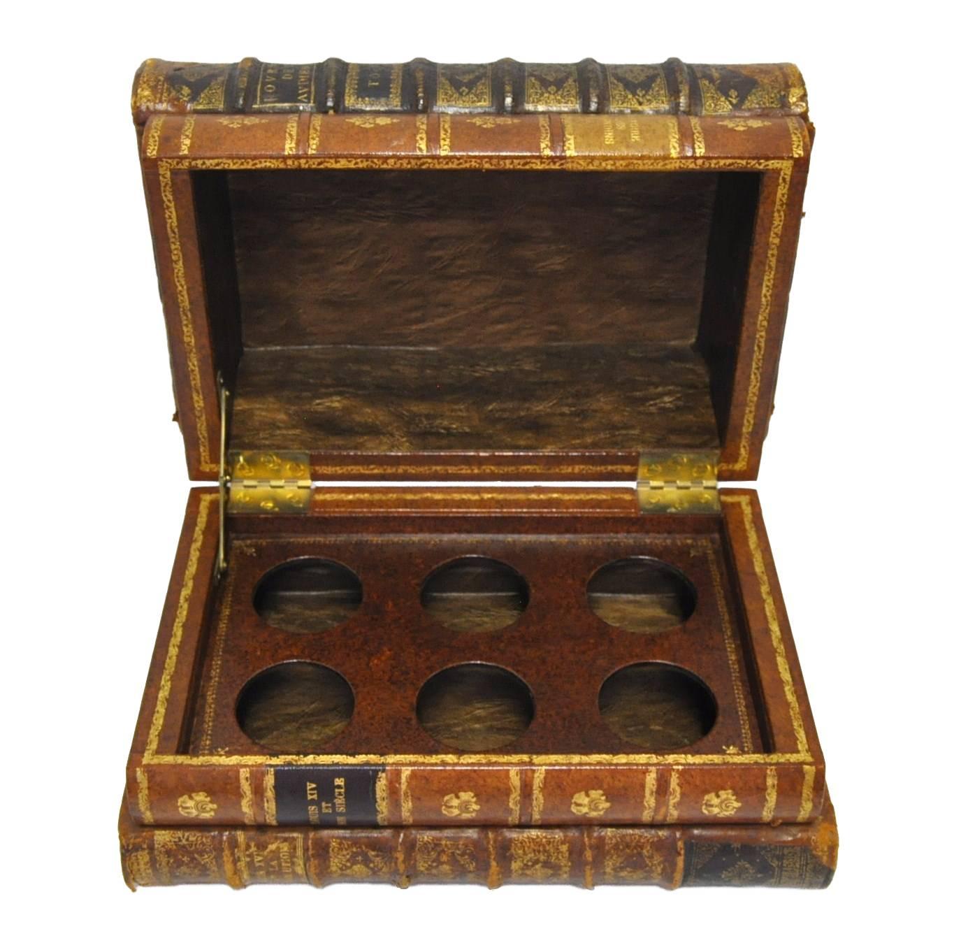 Beautiful six-liquor bottles holder box from France, circa 1870, made with four leather bound books shells. Very good condition and the books look real with the red tabs! The wood tray is removable, so the box could be used for different purpose.