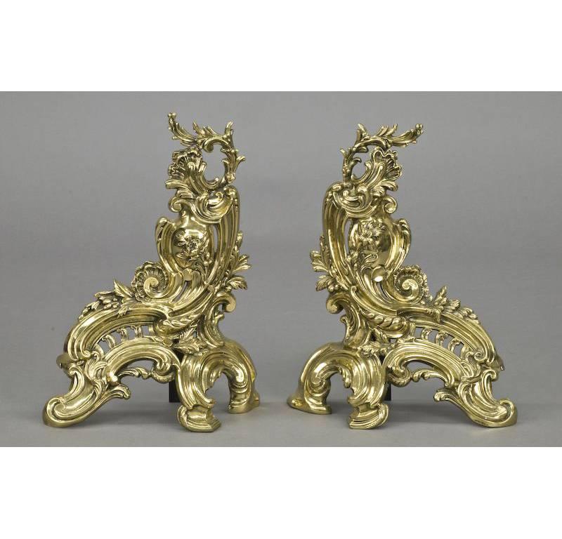 This beautiful, three-piece set would add classic French elegance to your home fireplace; crafted in France, circa 1890, the set is made up of two gilt bronze chenets andirons, and a large, matching fender. Each piece is decorated with a swirling