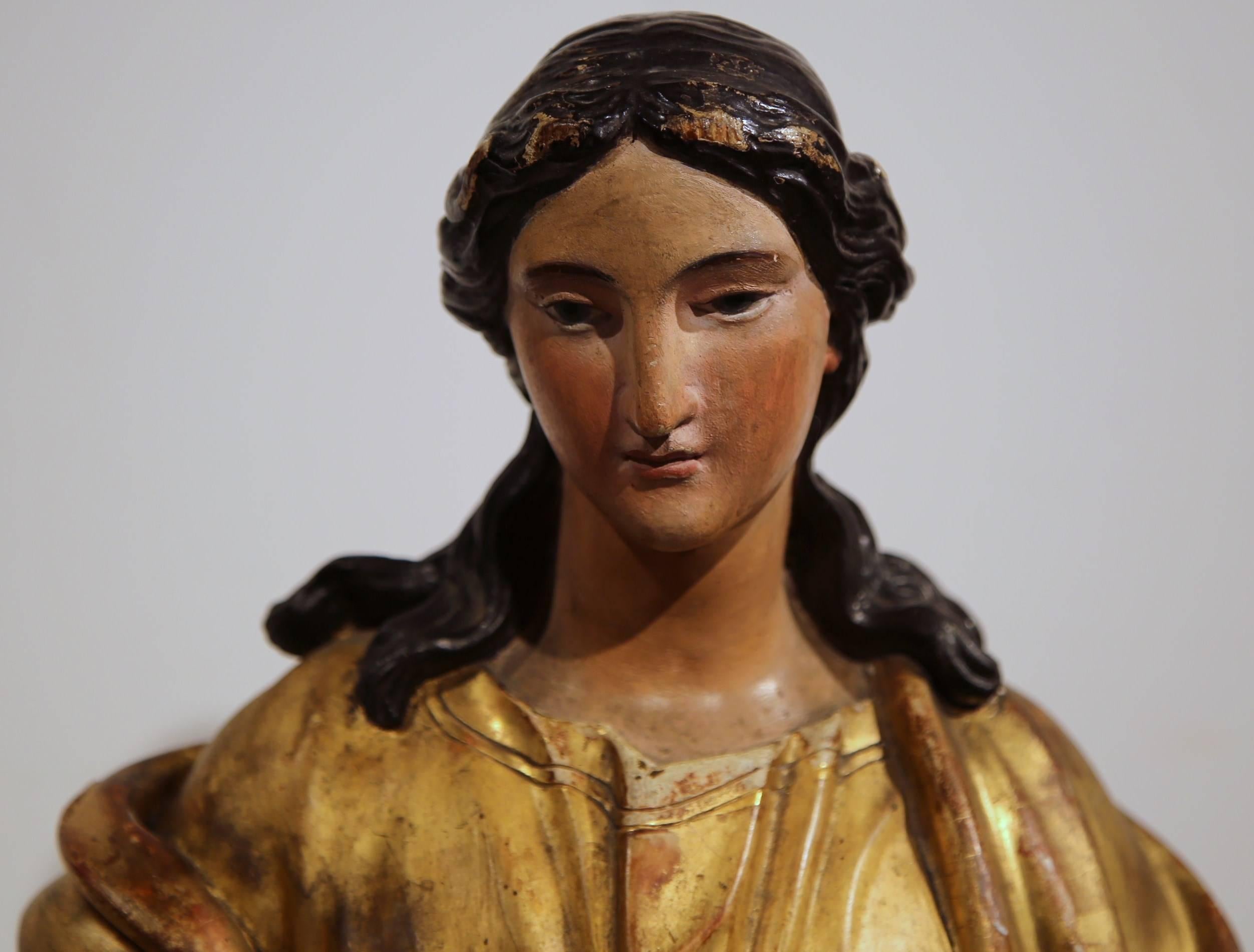 virgin mary standing on globe