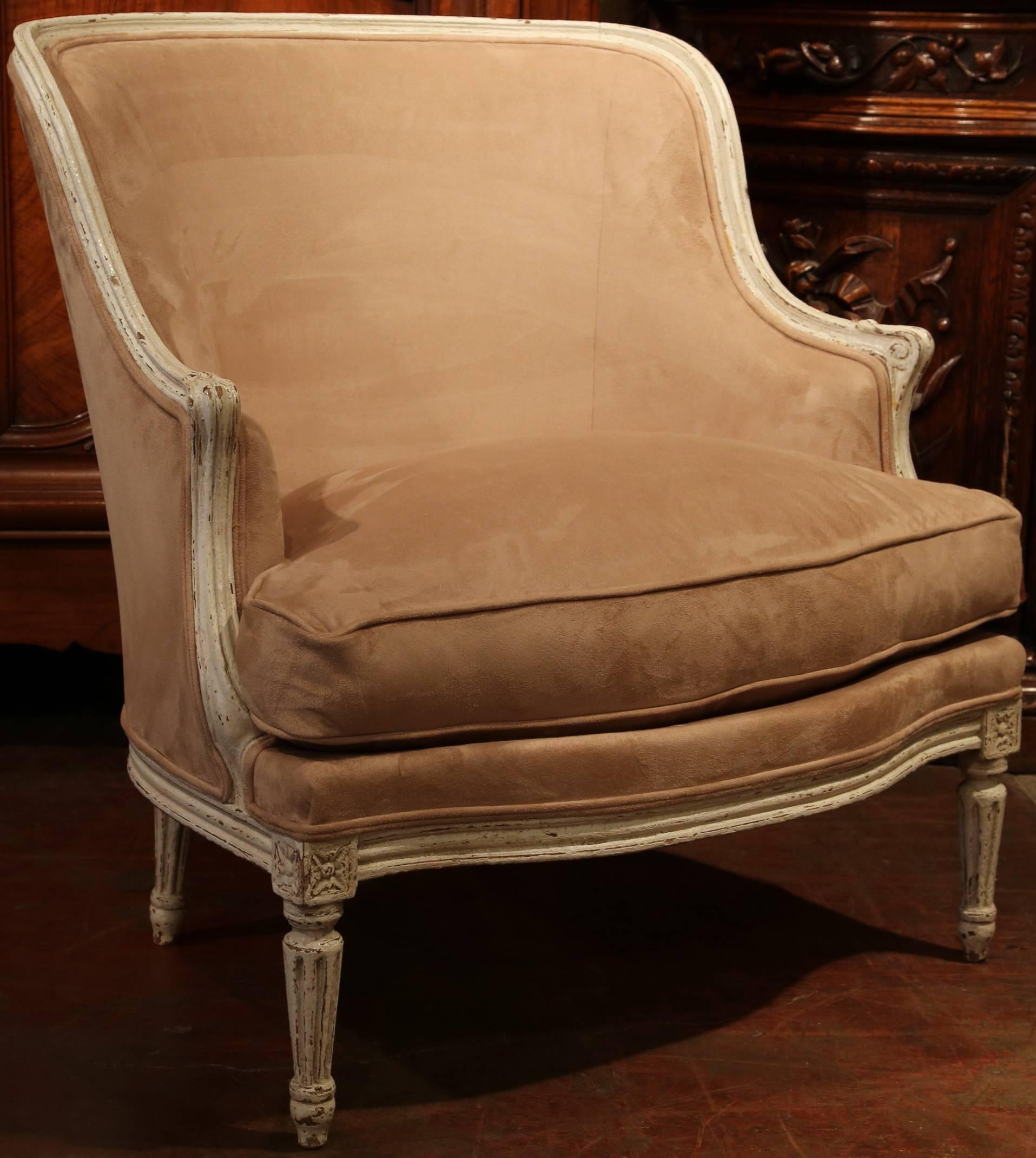 This elegant pair of antique painted armchairs was created in France circa 1880. These chairs have fluted legs, wide seats, curved backs and have been reupholstered with a beige suede fabric and down feathers. Incorporate these comfortable chairs