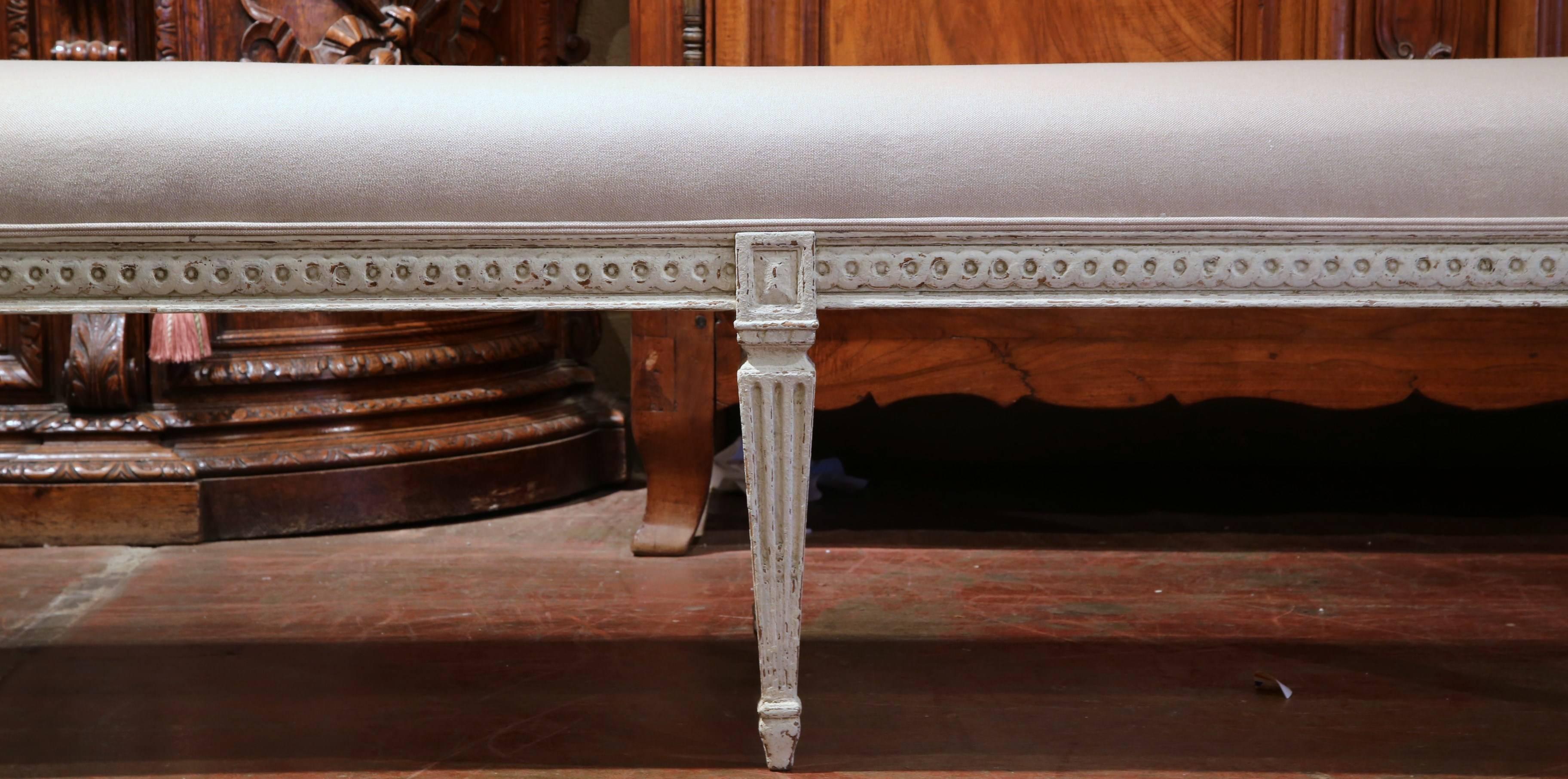 Pair of fine antique Louis 16 benches from France, circa 1880. With six tapered legs with carvings around the apron and reupholstered with thick grey toile, these benches are the perfect sizes at the end of a king-size bed!